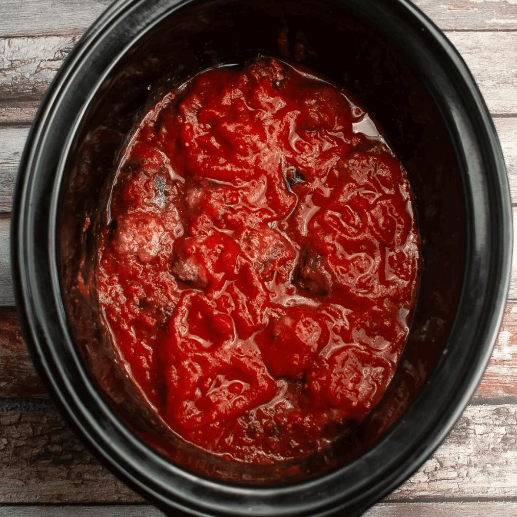 meatballs in slow cooker dish covered with marinara