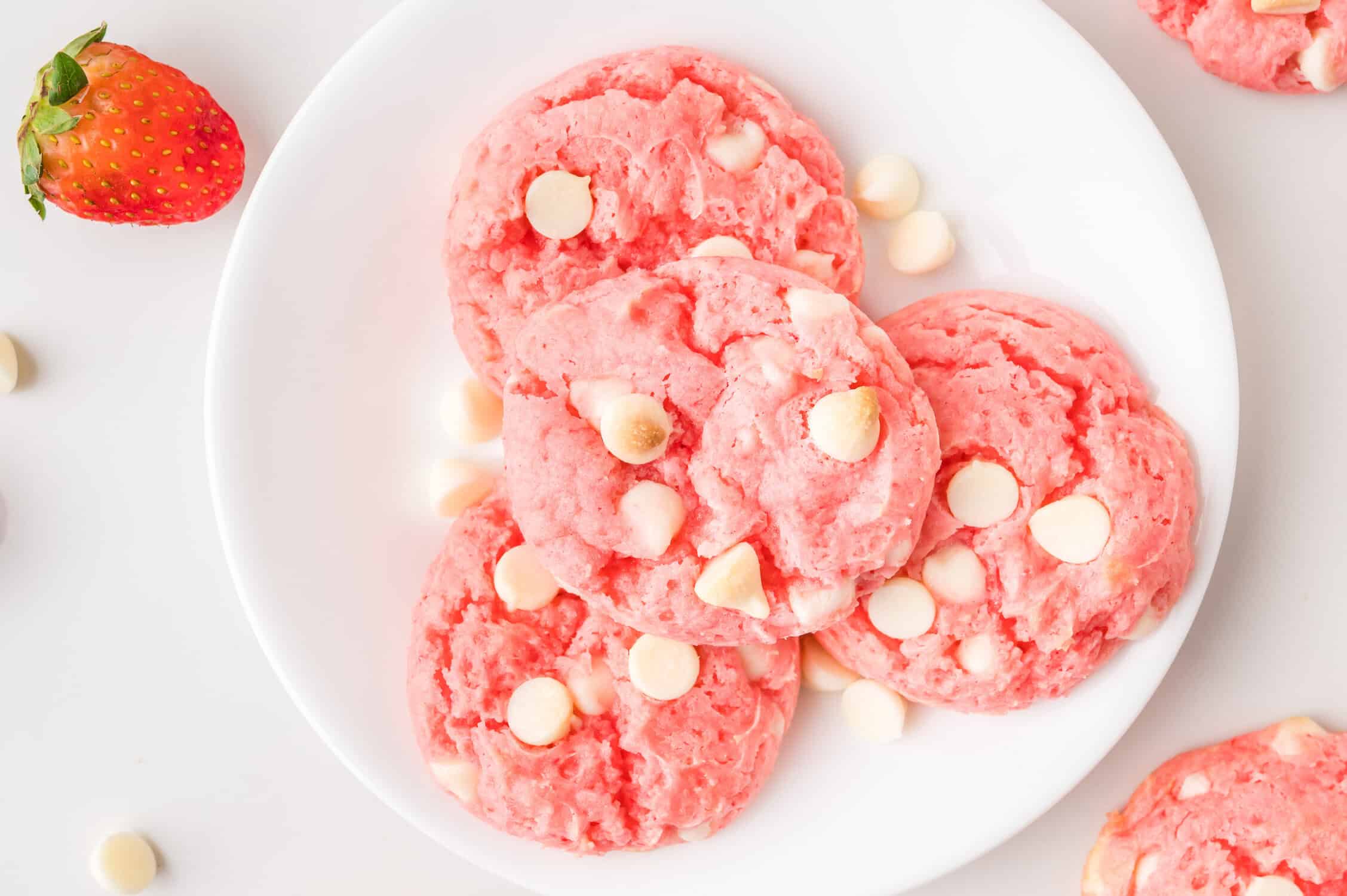 strawberry cake mix cookies stacked on a plate