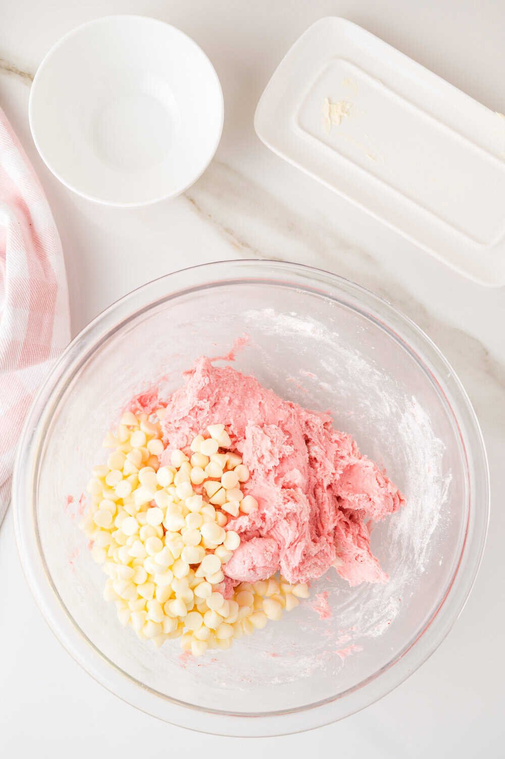 strawberry cake mix cookies dough with white chocolate chips on top