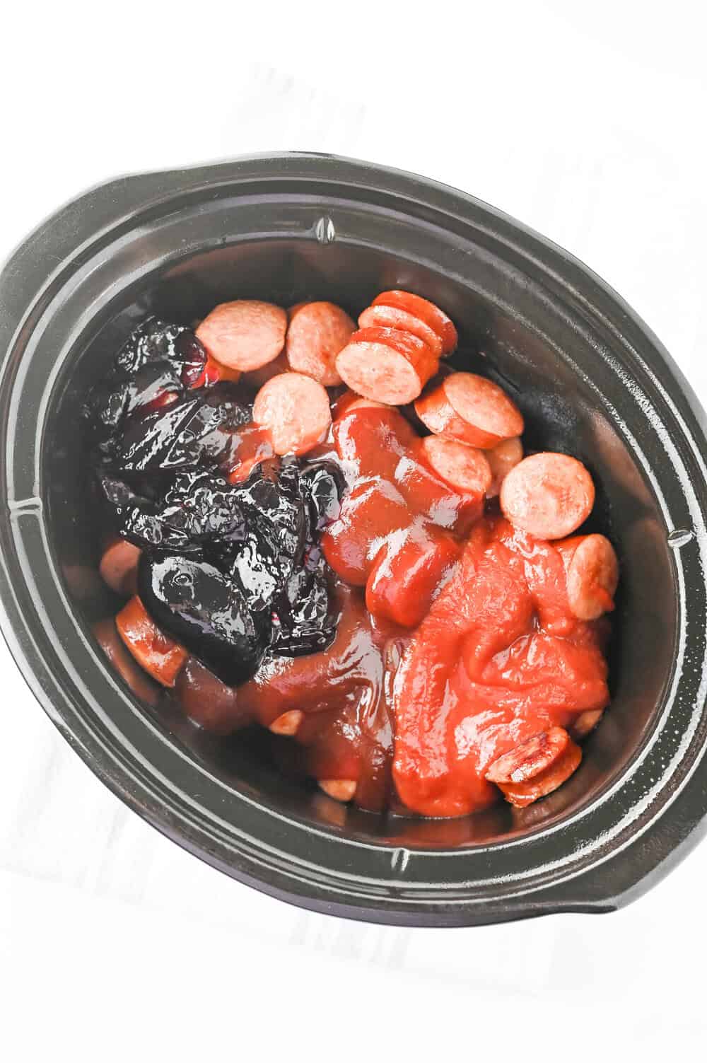 slow cooker kielbasa bites ingredients in a crock pot