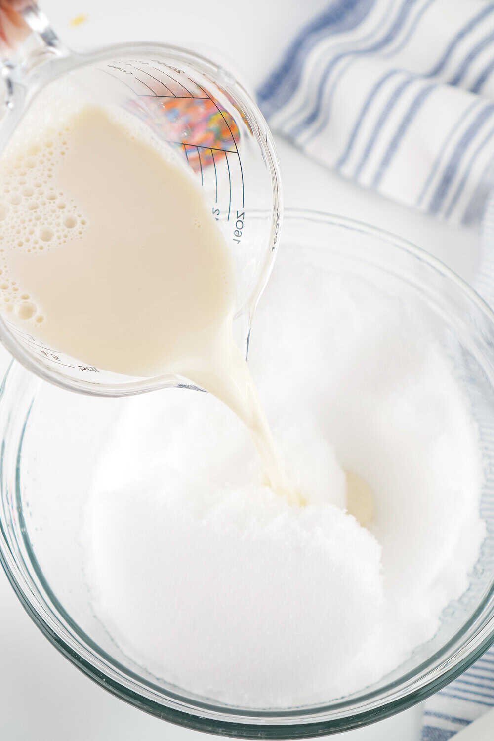 adding milk mixture to bowl