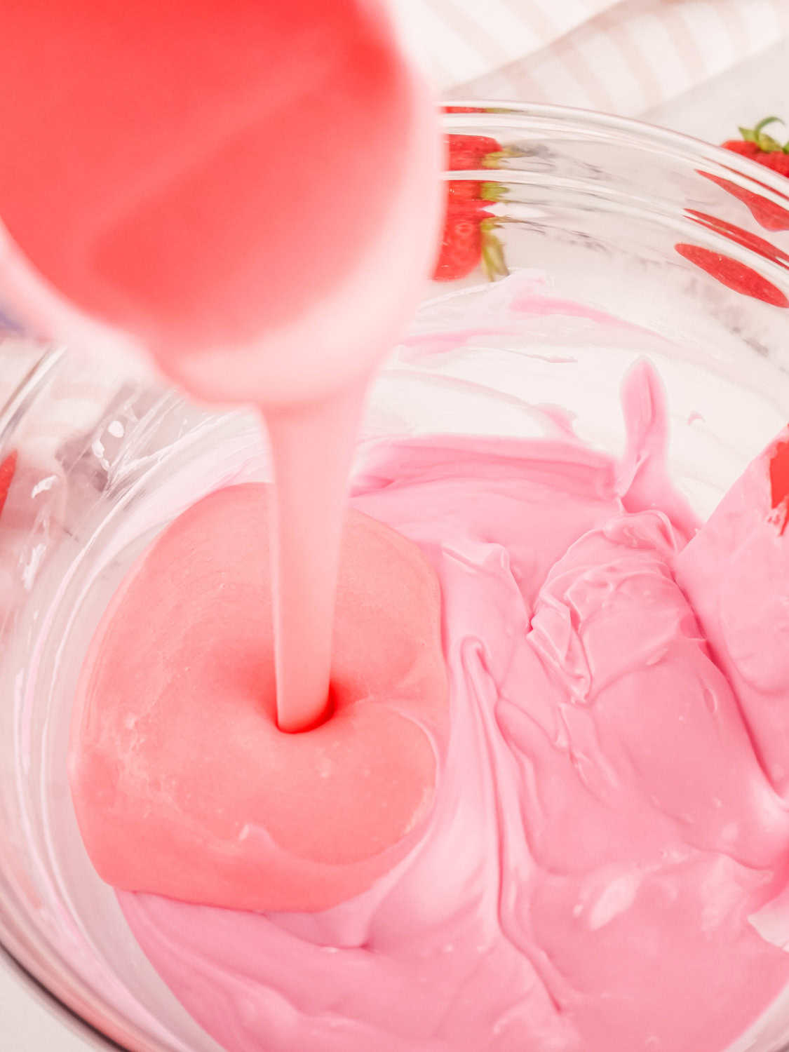 pouring melted frosting into melted candy melts