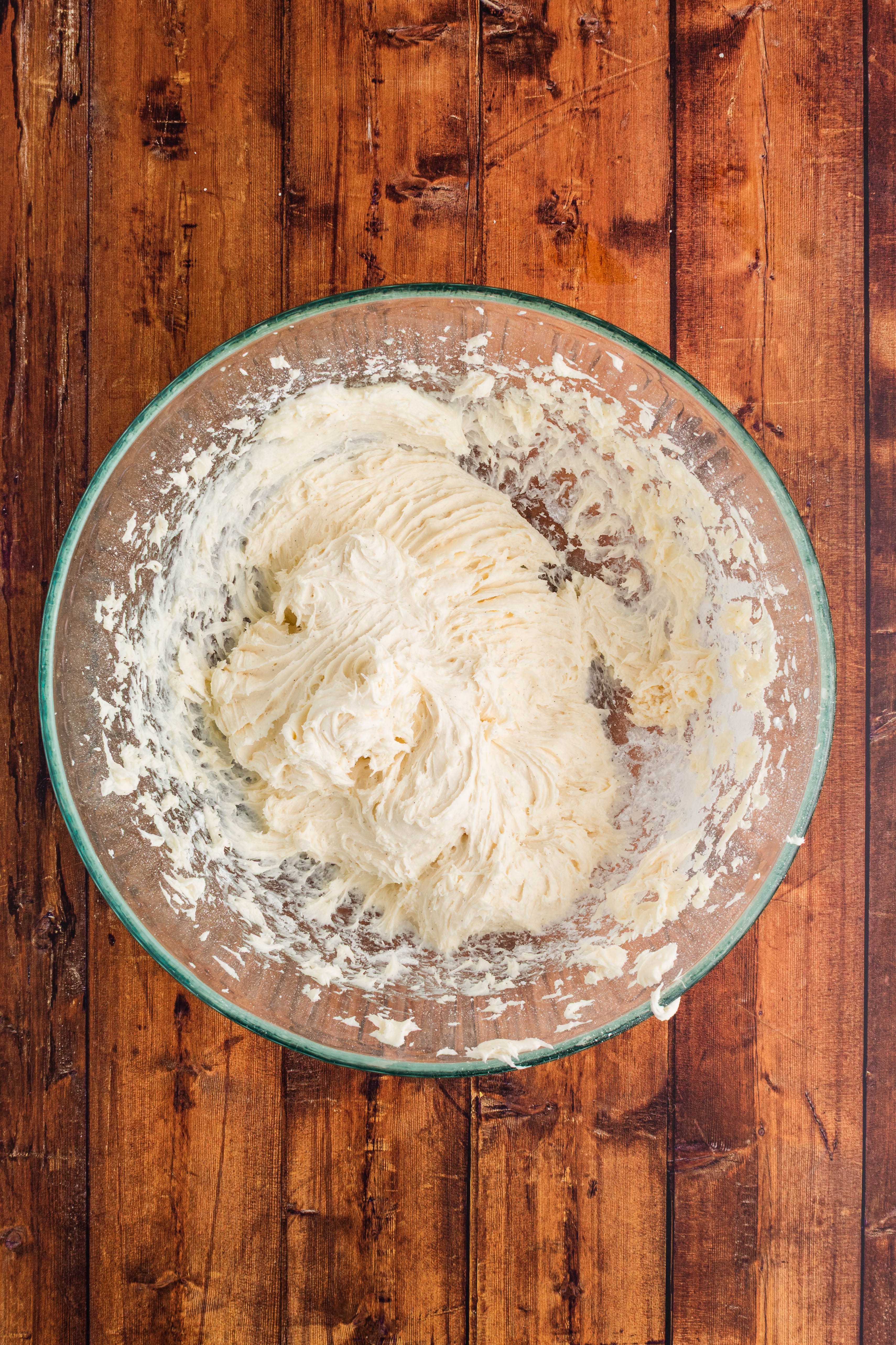 cream cheese frosting mixed up in mixer bowl