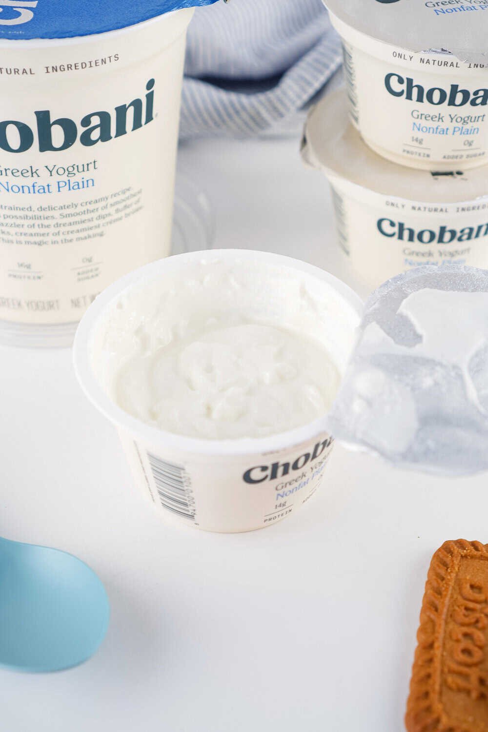 small cup of greek yogurt with foil pulled back