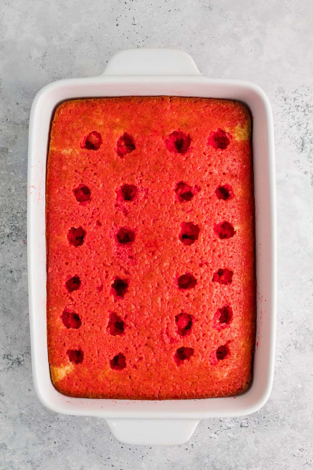strawberry jello poured over baked vanilla cake