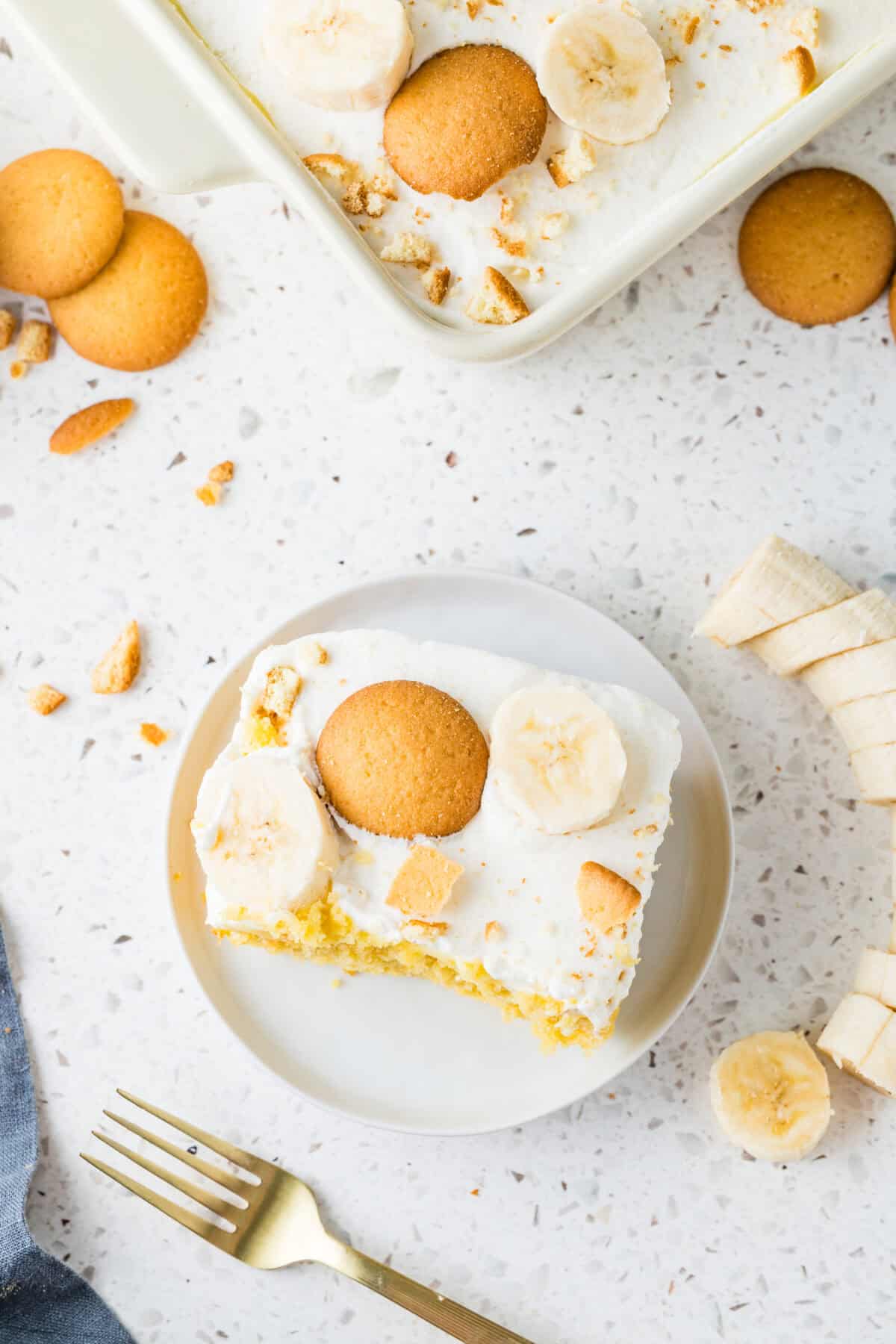 slice of banana pudding poke cake on a white plate