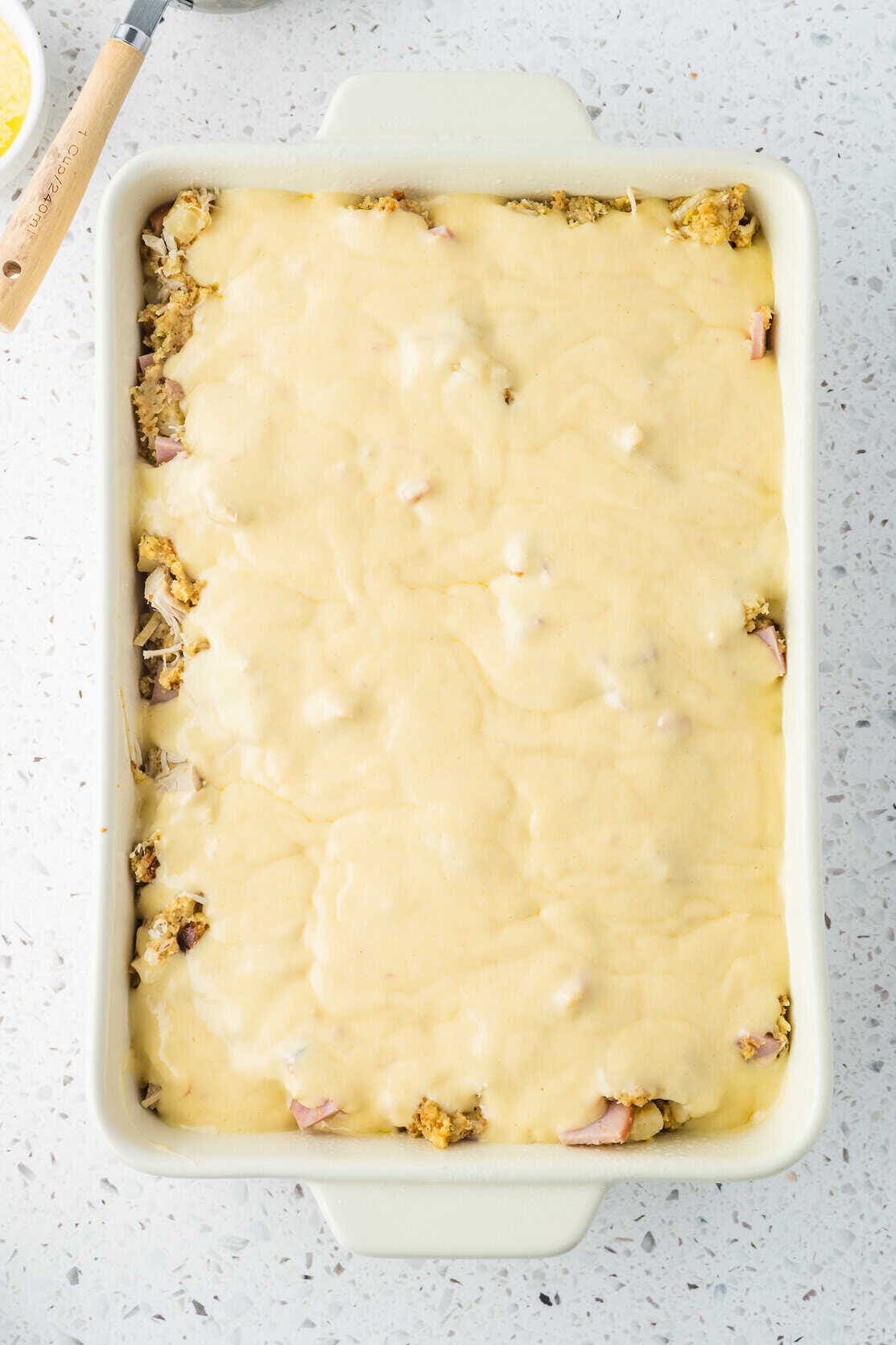 sauce poured over the top of the chicken cordon bleu casserole