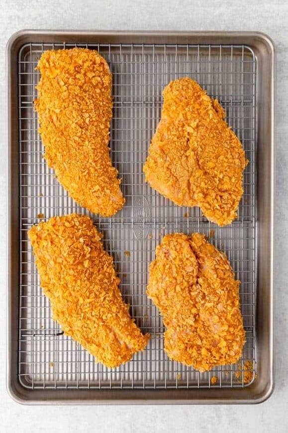 cornflake breaded chicken on wire rack