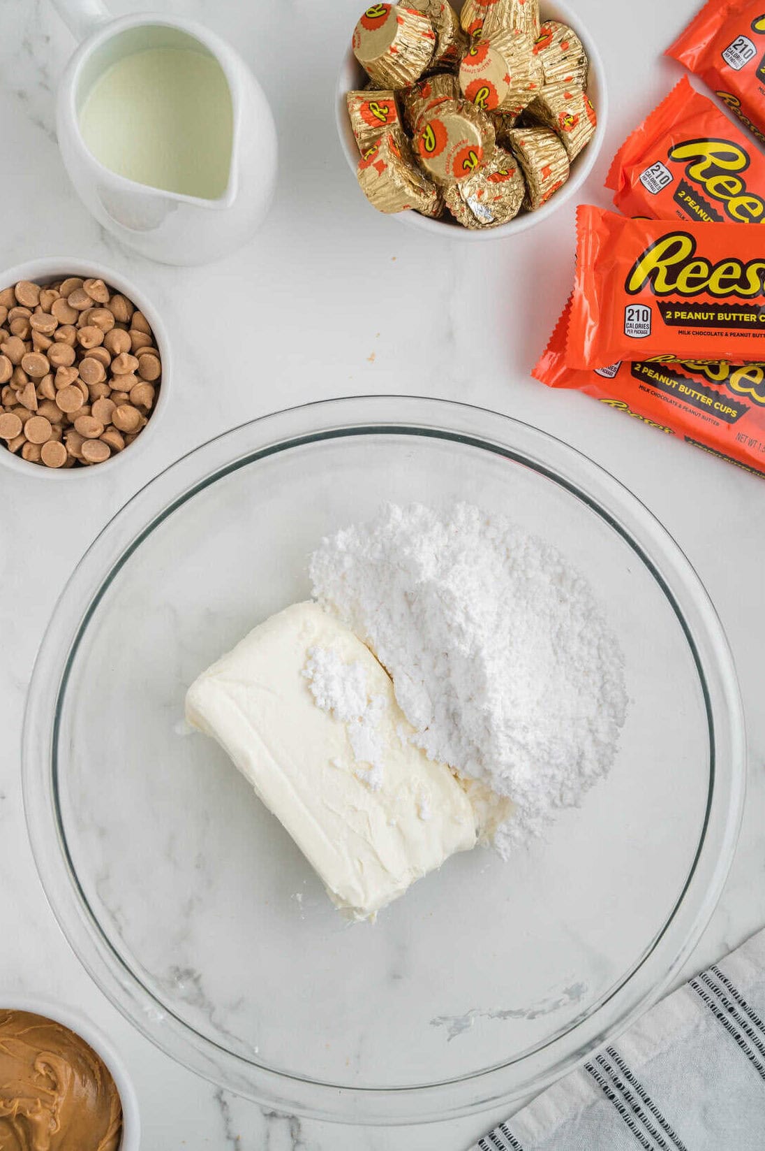 cream cheese and powdered sugar in clear mixing bowl