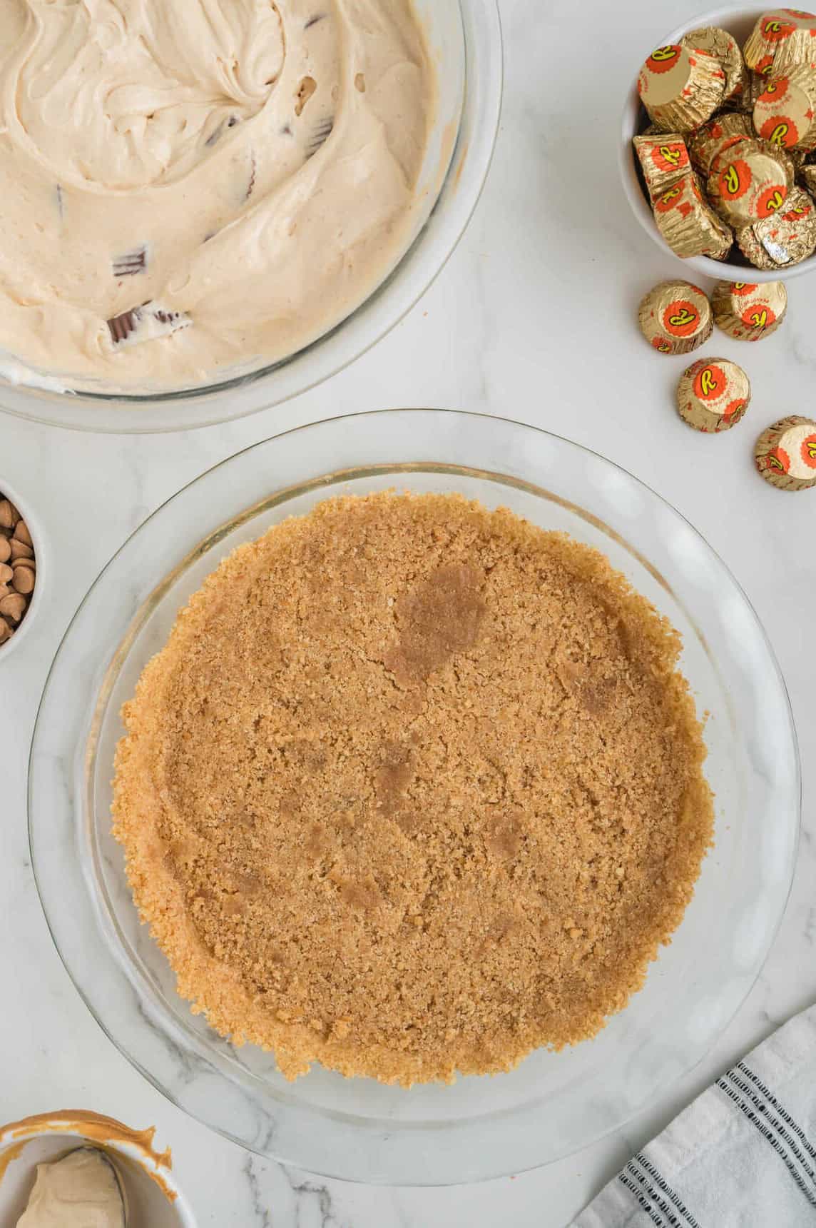 baked graham cracker pie crust in clear pie plate
