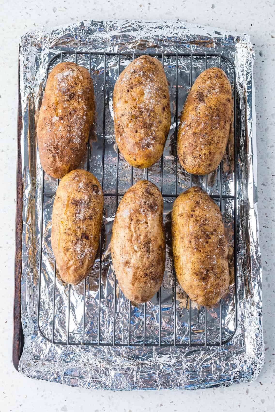 baked potatoes on baking sheet with wire rack