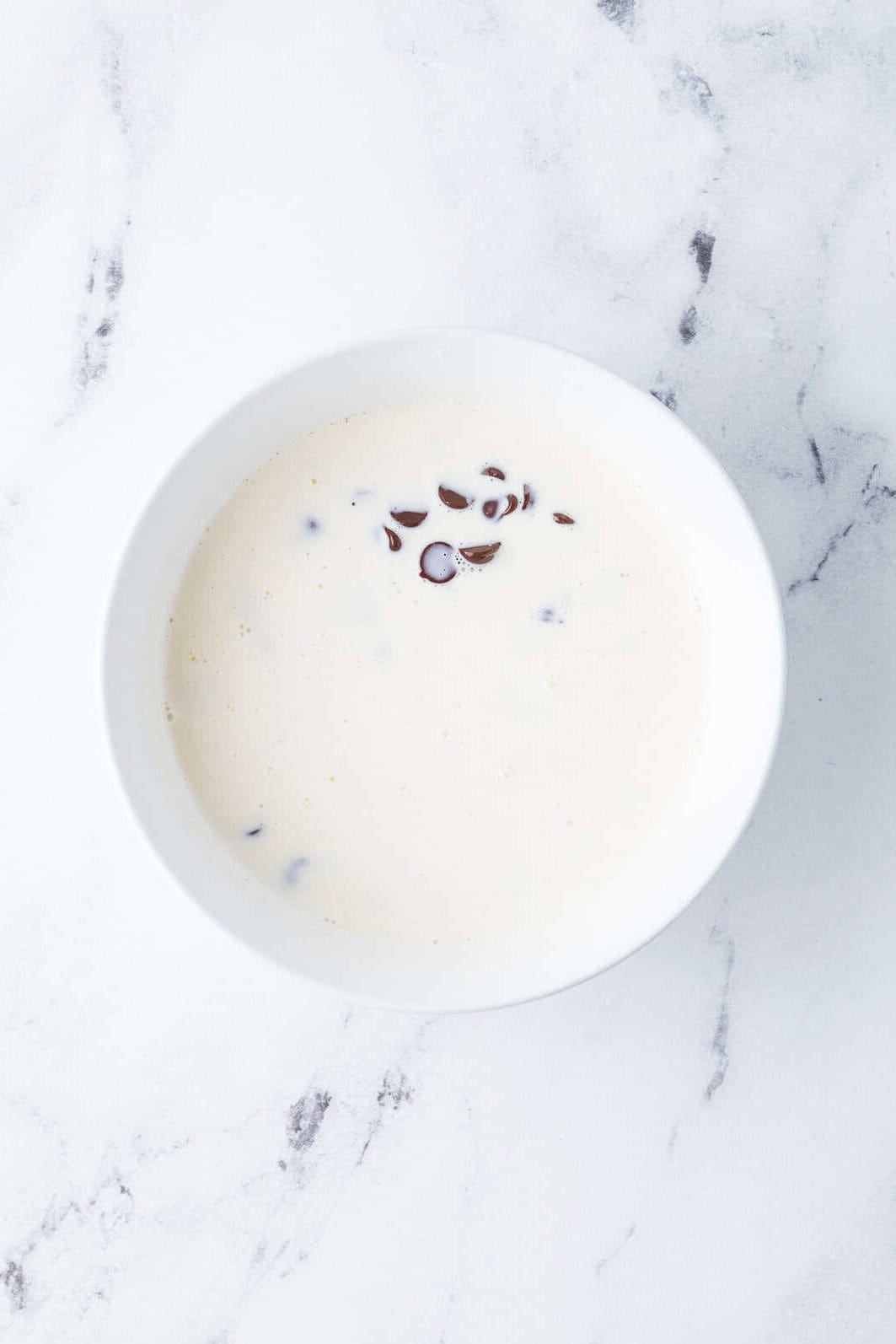 heavy cream poured over chocolate chips