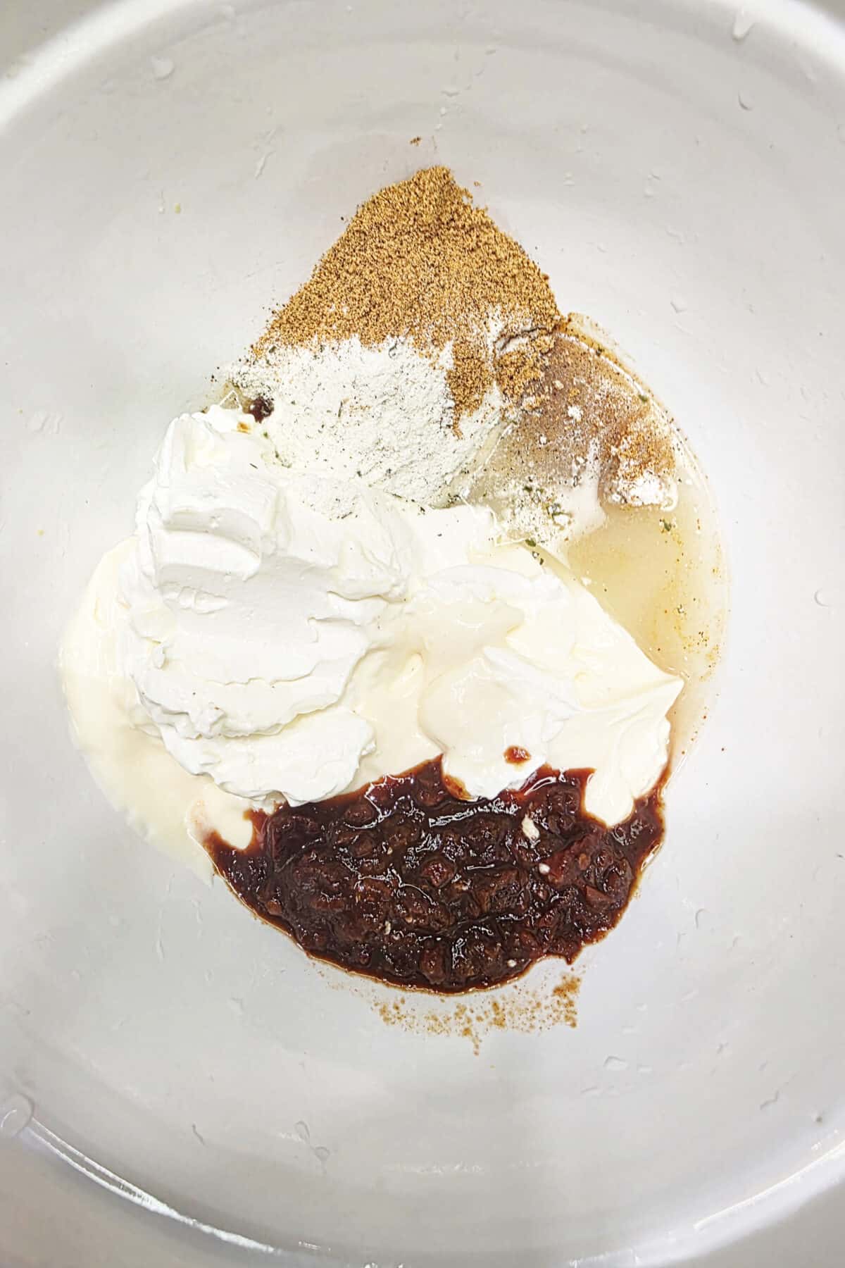 cream and zesty coleslaw dressing ingredients in a bowl