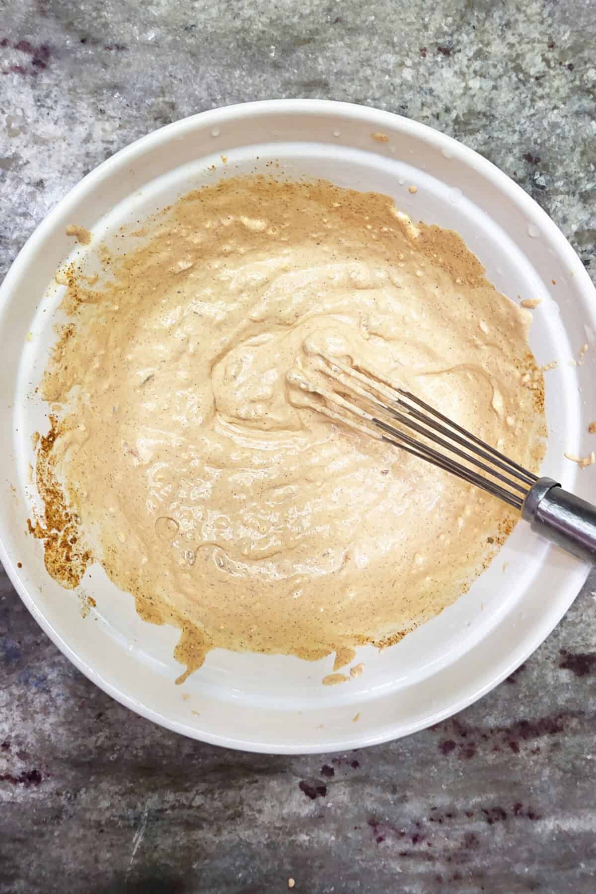 cream and zesty coleslaw dressing ingredients in a bowl