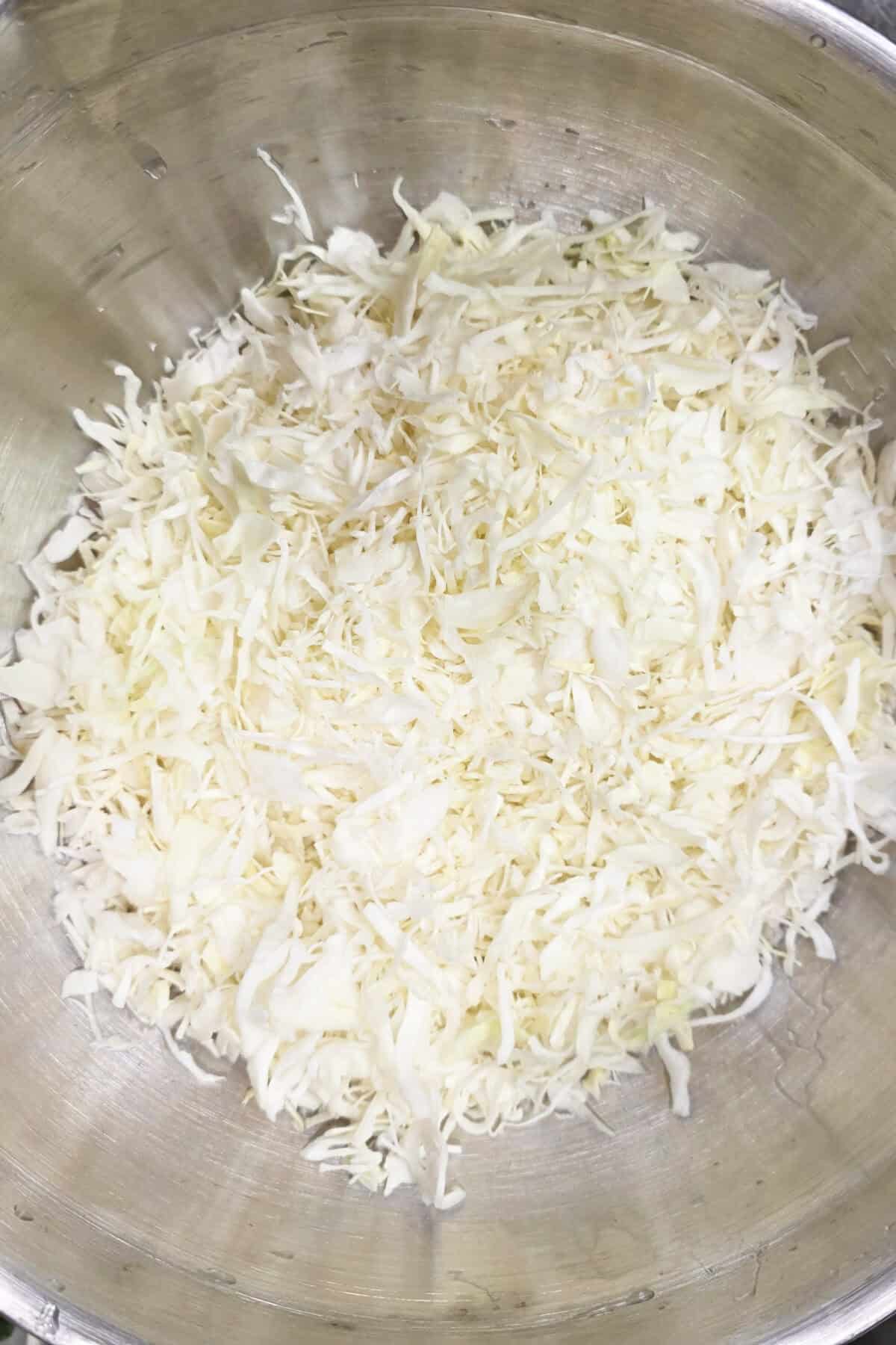 shredded coleslaw in a large mixing bowl