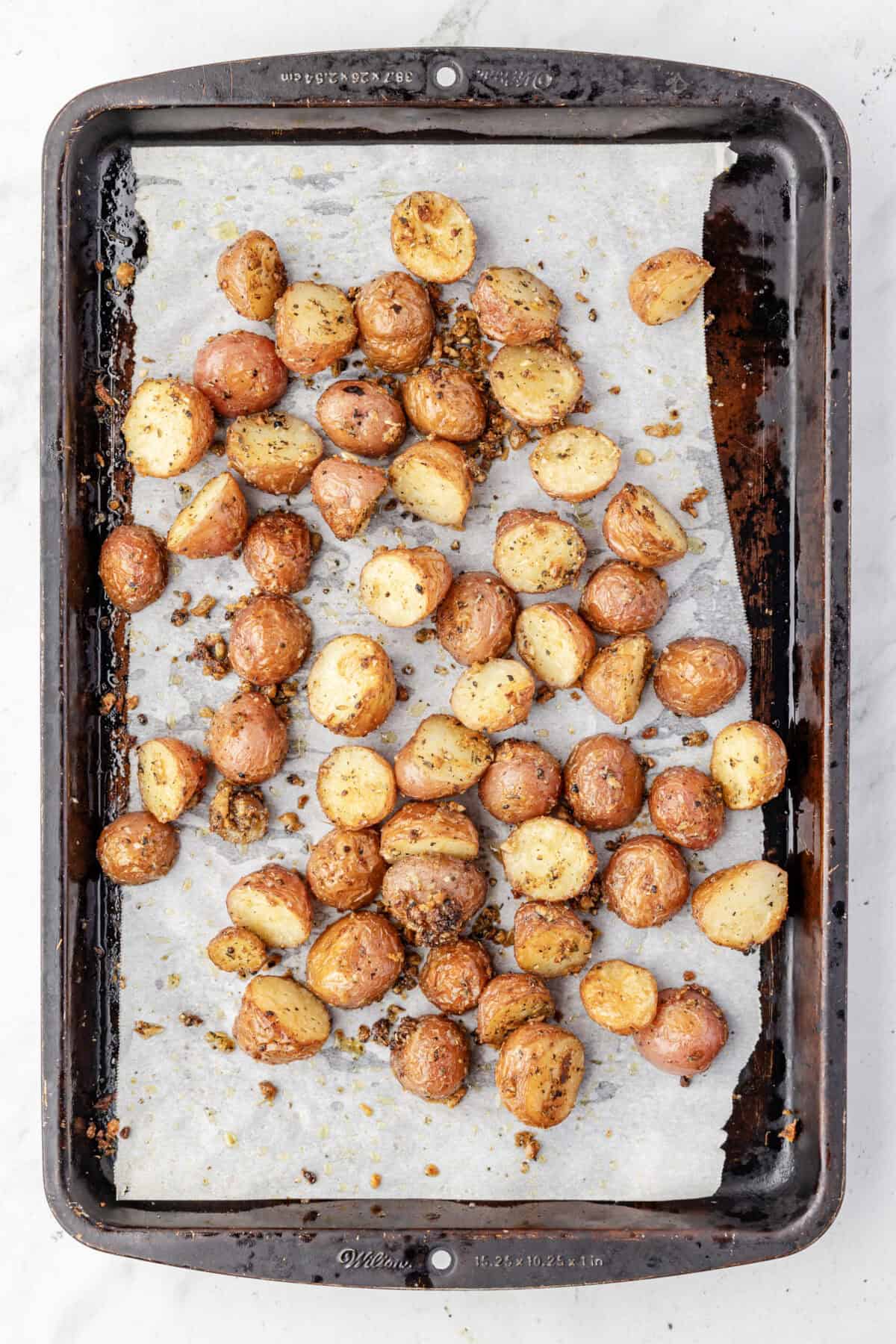roasted garlic parmesan potatoes on a baking sheet