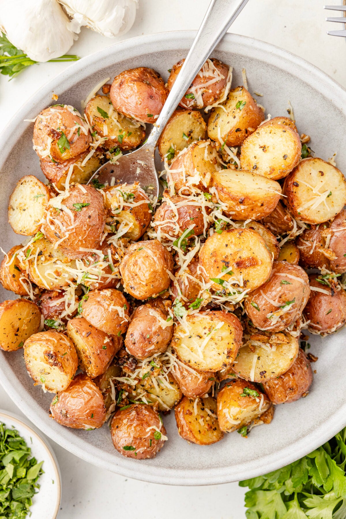 garlic parmesan potatoes in white bowl