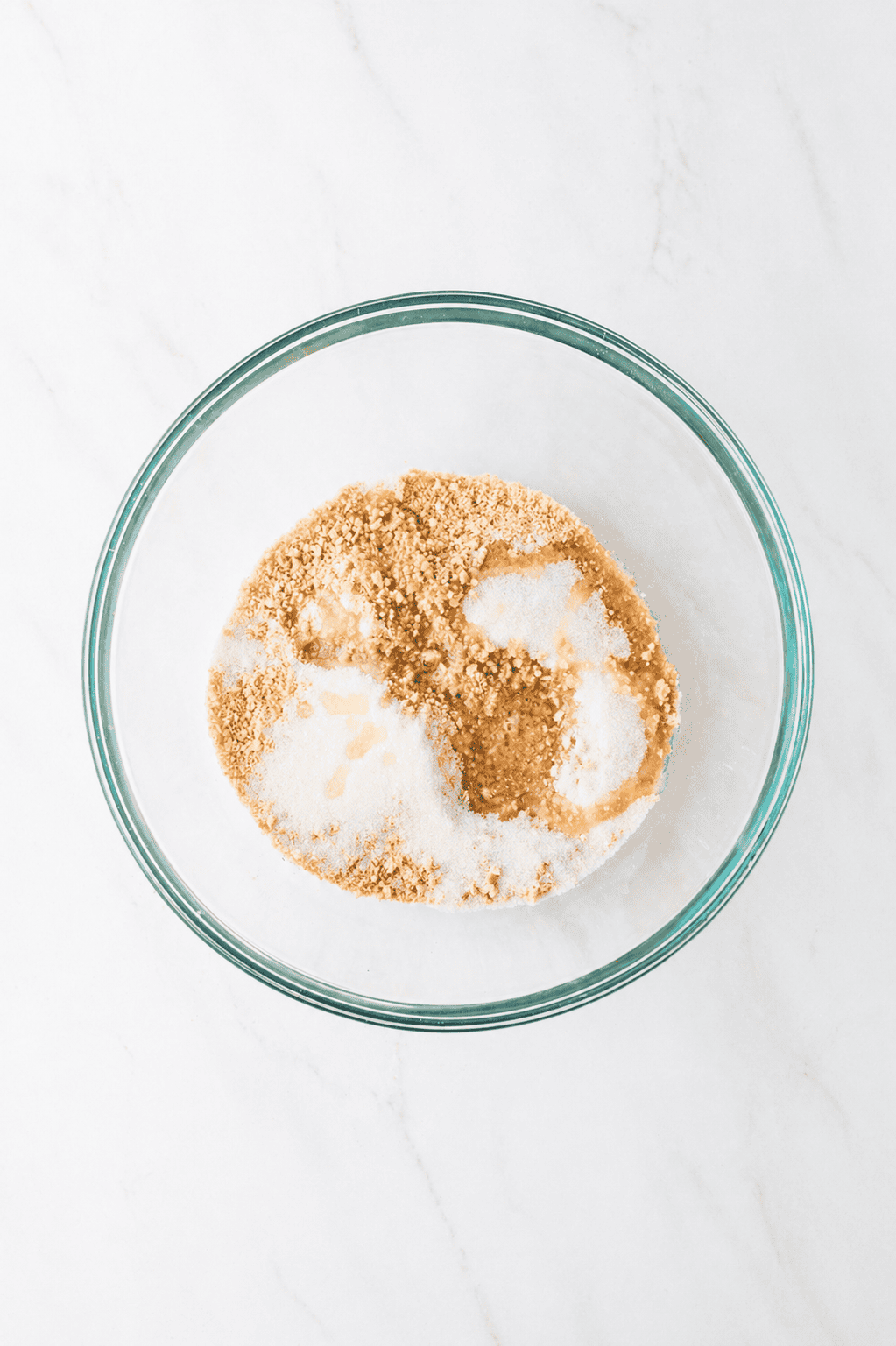 ingredients for graham cracker crust in a bowl