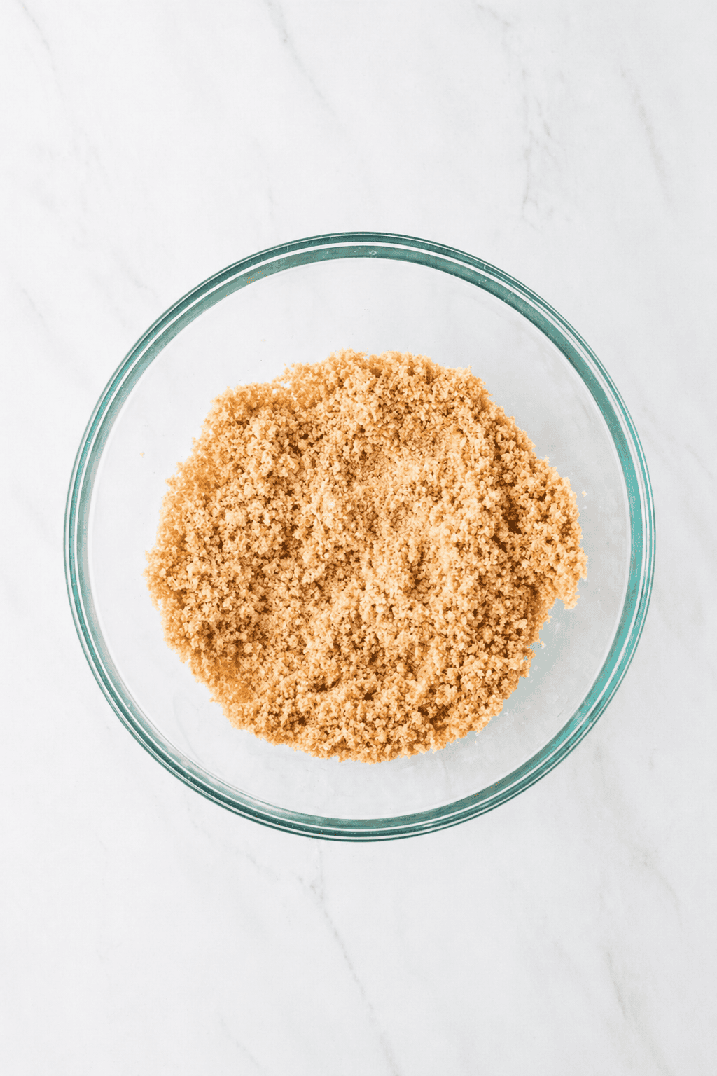 ingredients for graham cracker crust mixed in a bowl