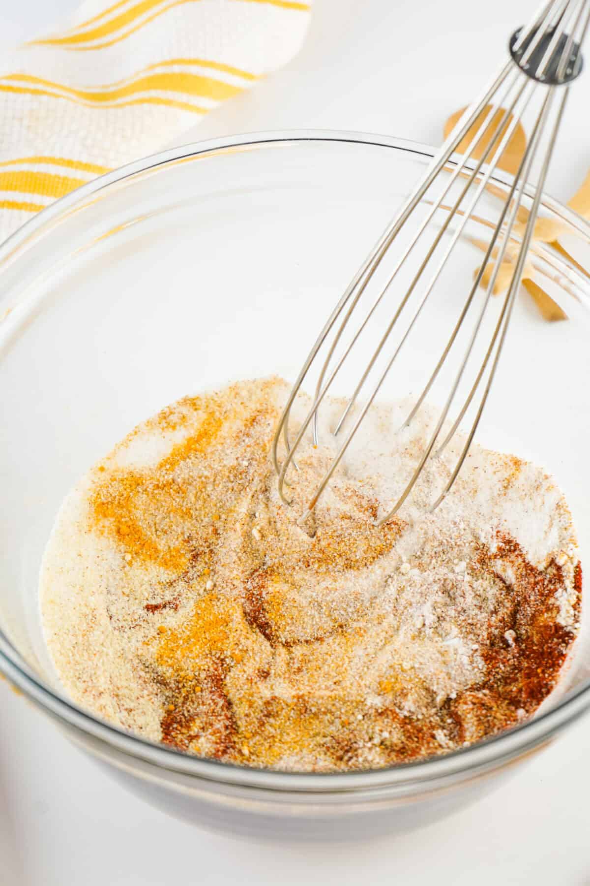 whisking together seasoned salt ingredients in a bowl