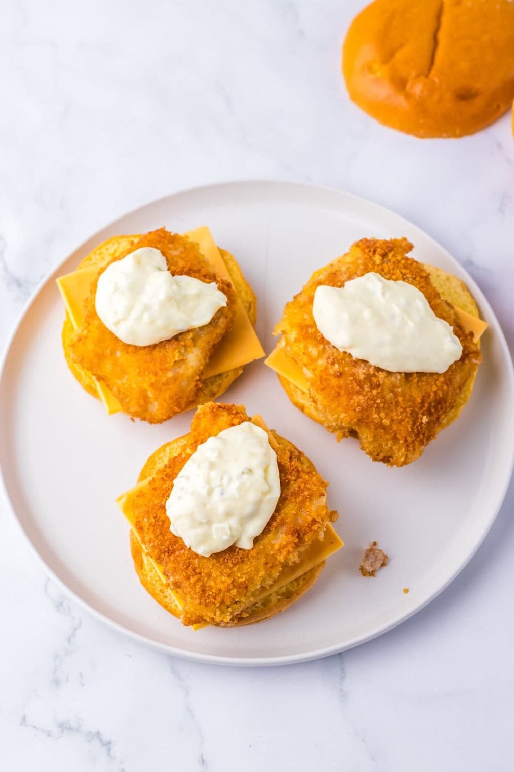 fish filet on a bun with cheese and tarter sauce