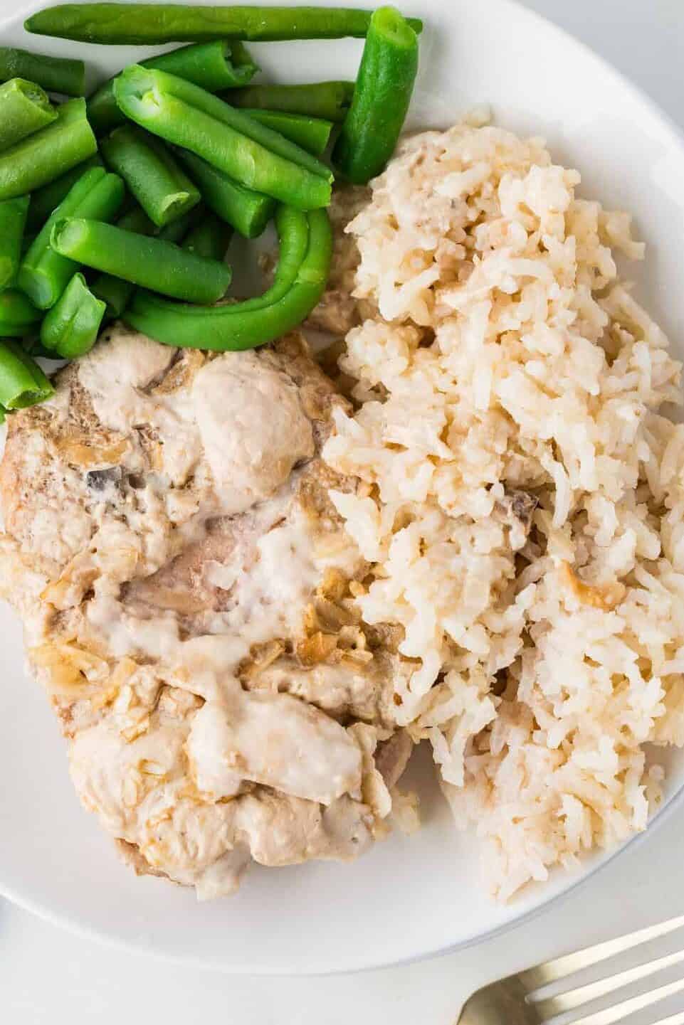 pork chops and rice on a plate with green beans