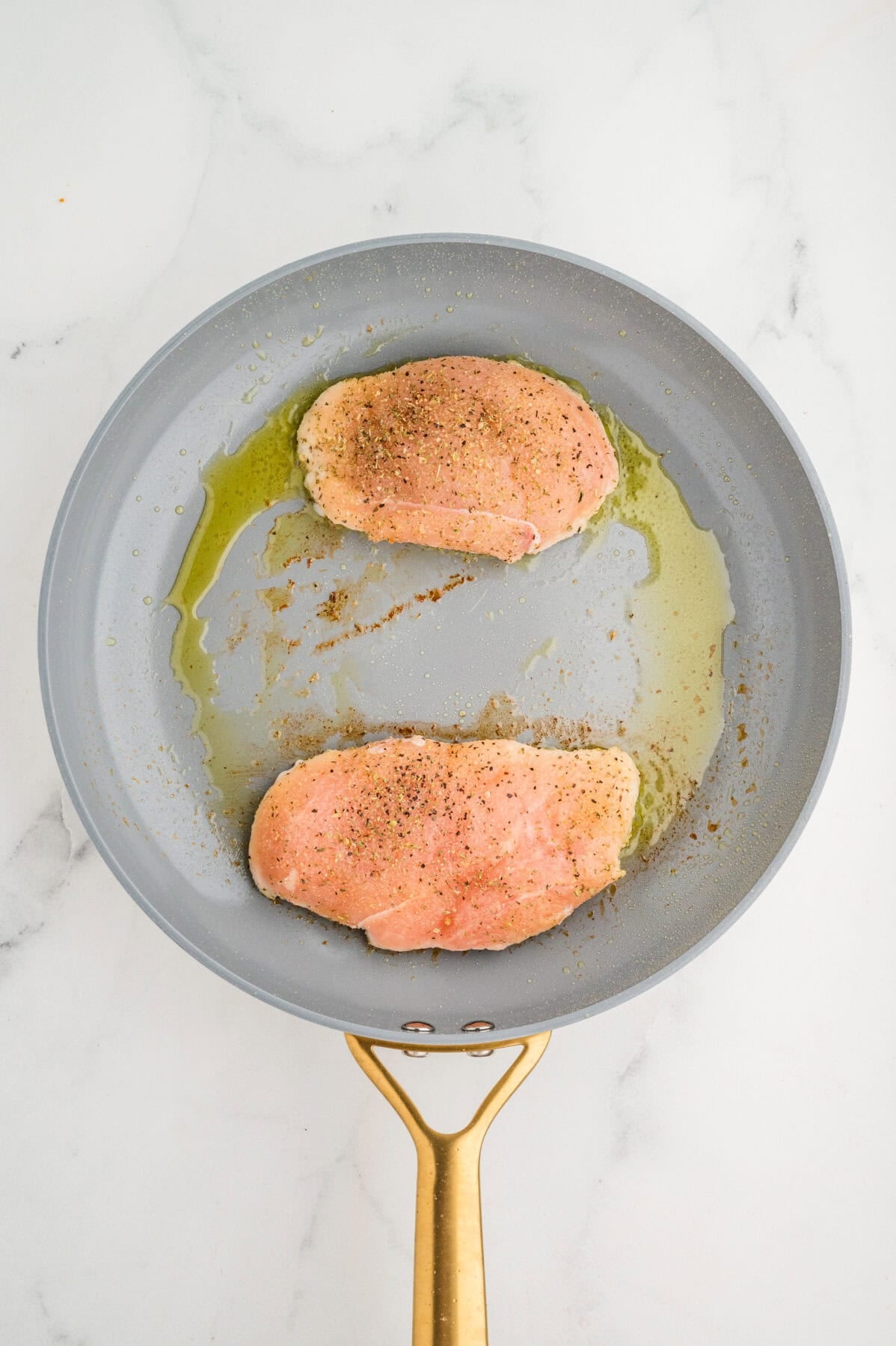 sauteing chicken breasts in a skillet