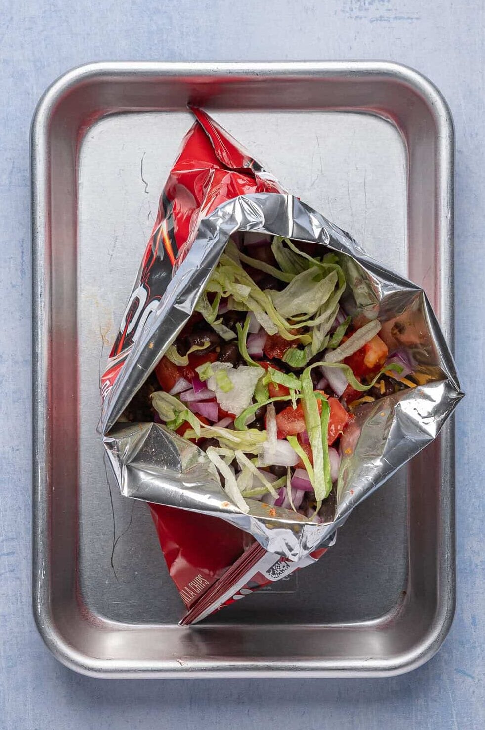 walking tacos with toppings inside