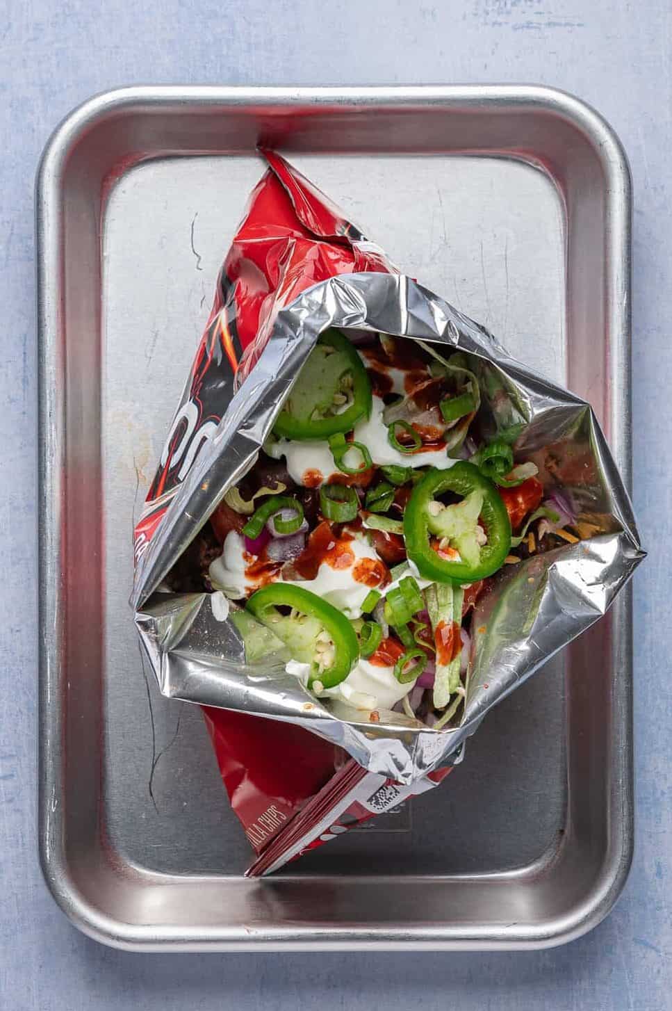 walking tacos with toppings inside