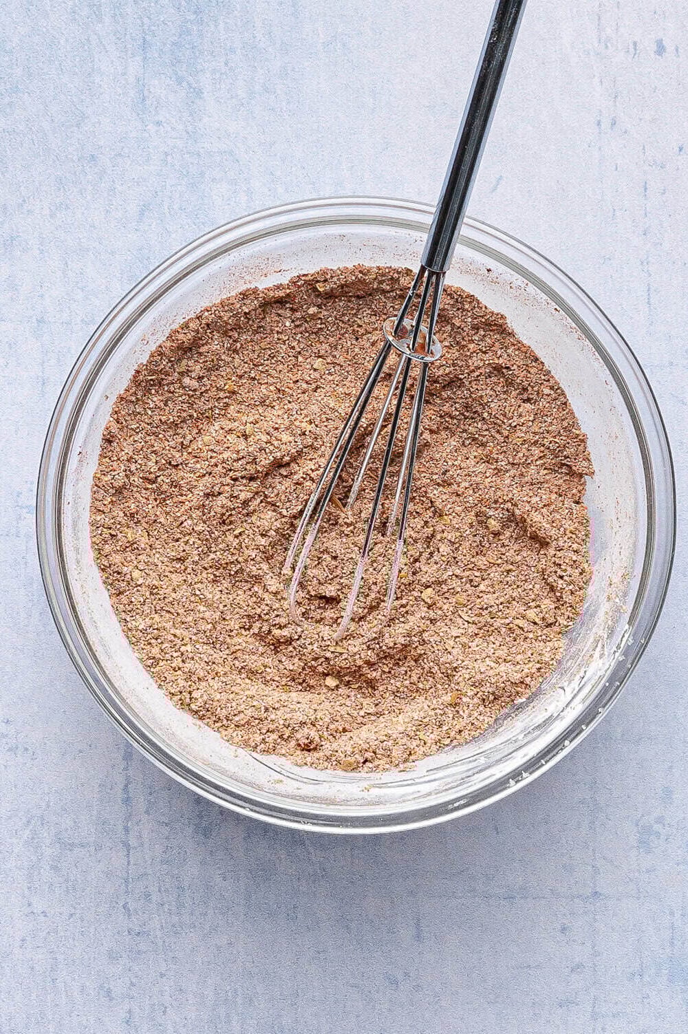 homemade taco seasoning in a bowl with a whisk