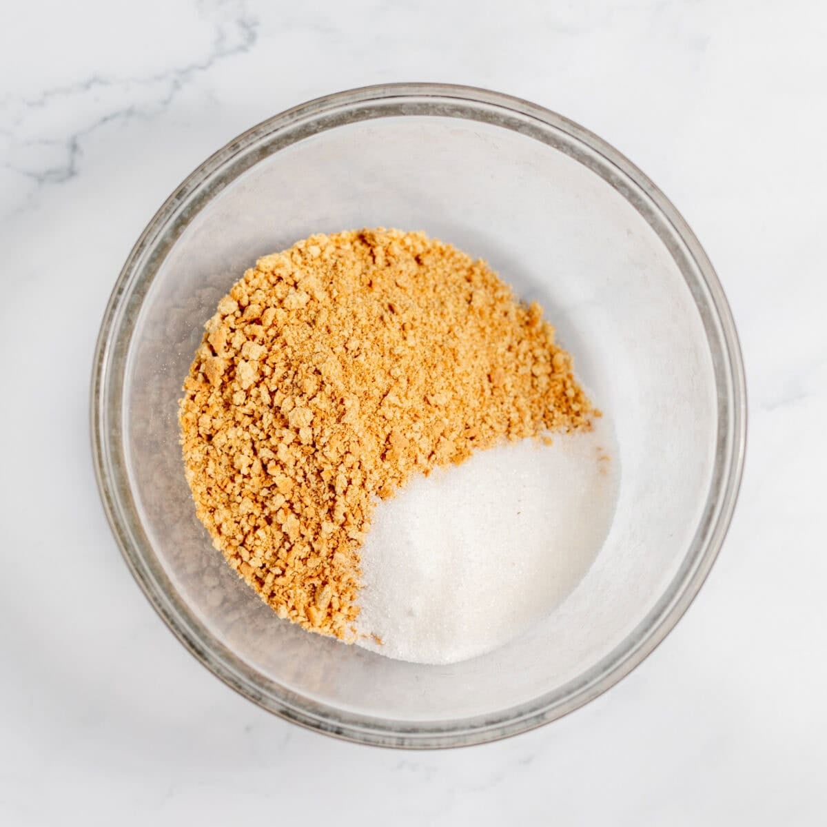 graham cracker crumbs and sugar in a bowl