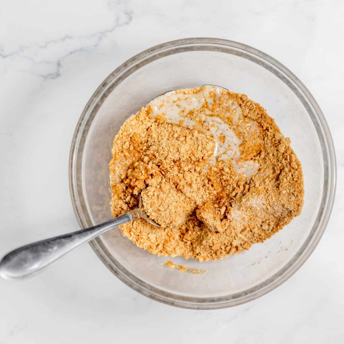 graham cracker crumbs, butter and sugar in a bowl