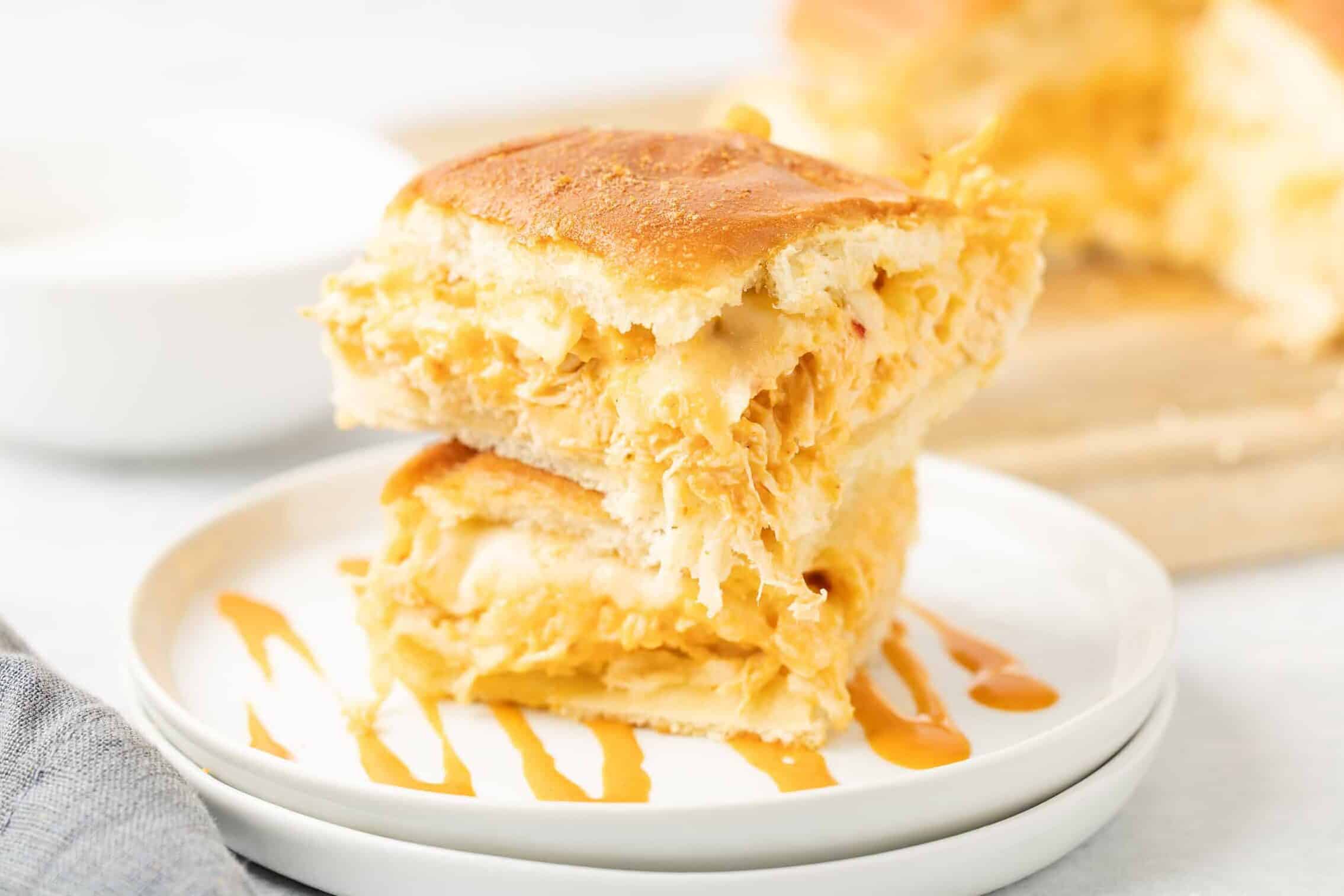 buffalo chicken sliders stacked on a plate