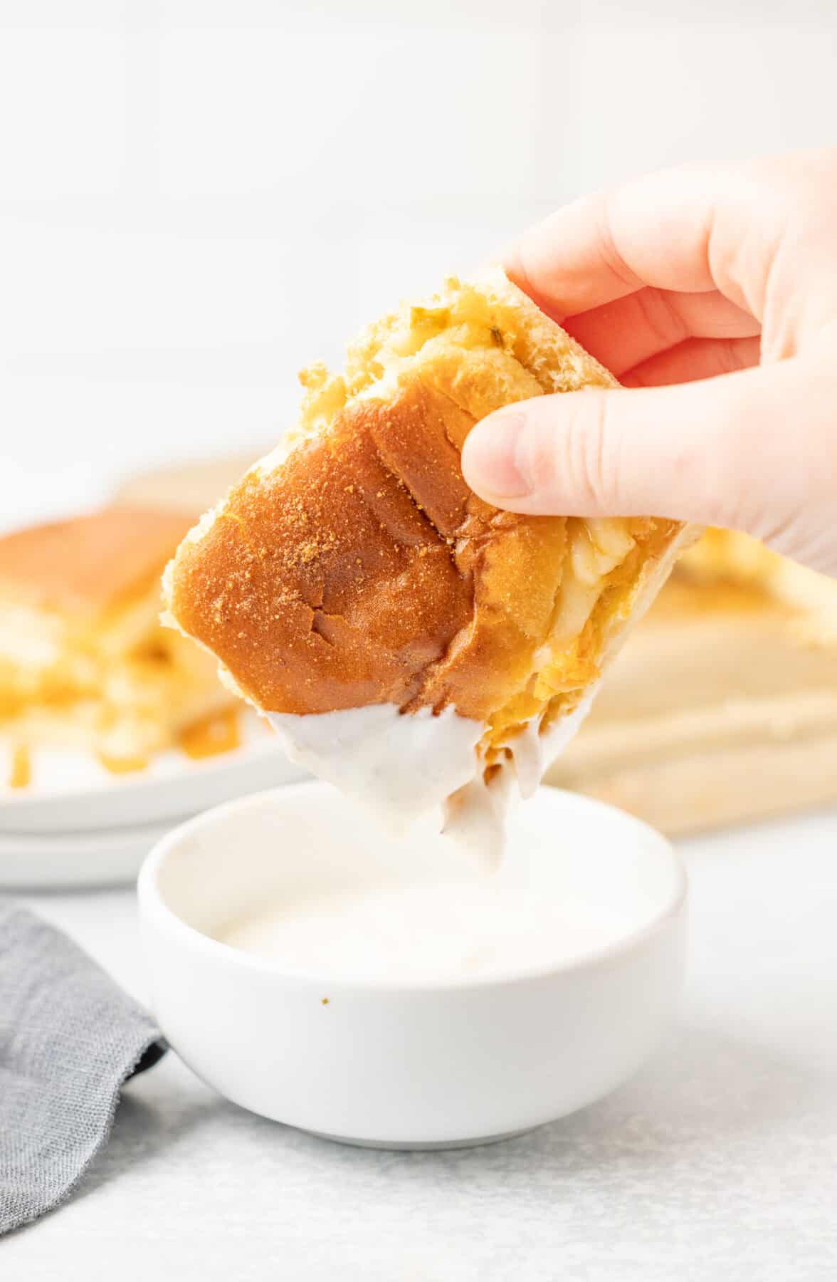 dipping a buffalo chicken slider into ranch dressing