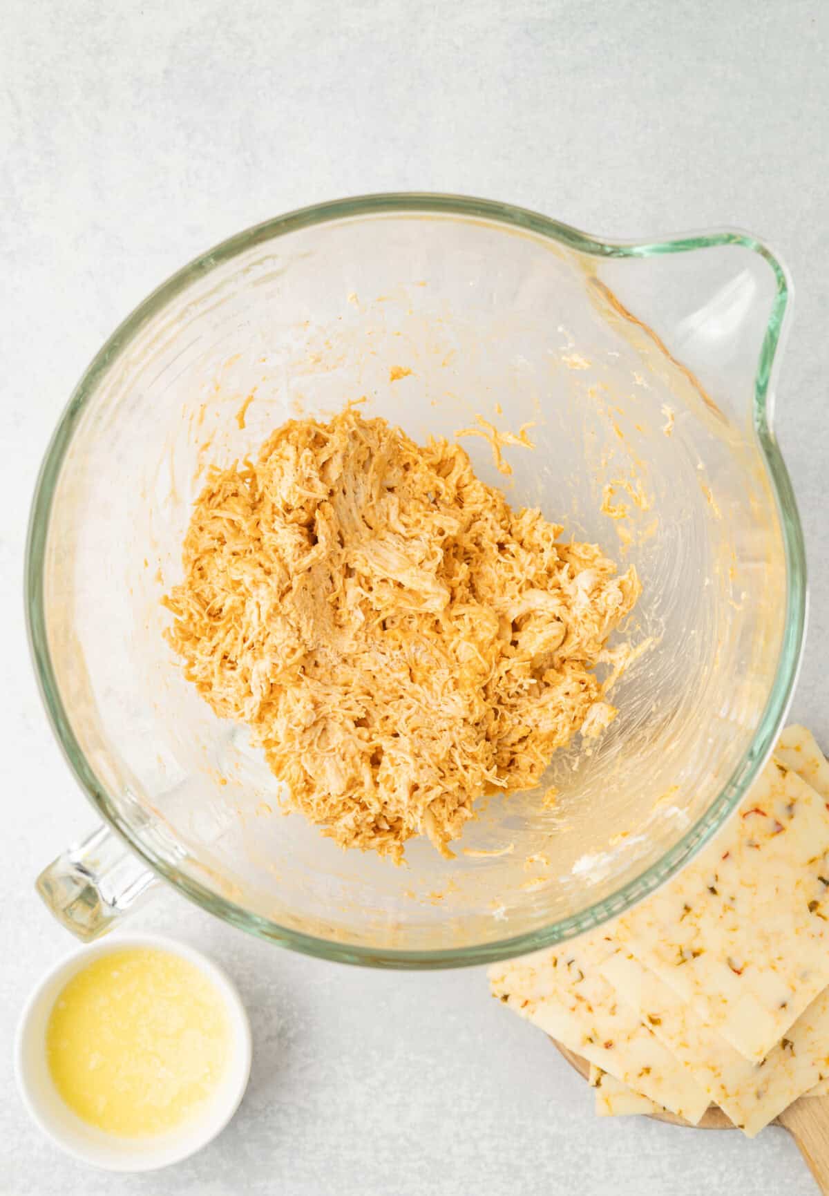 shredded chicken with buffalo sauce and seasonings in a bowl