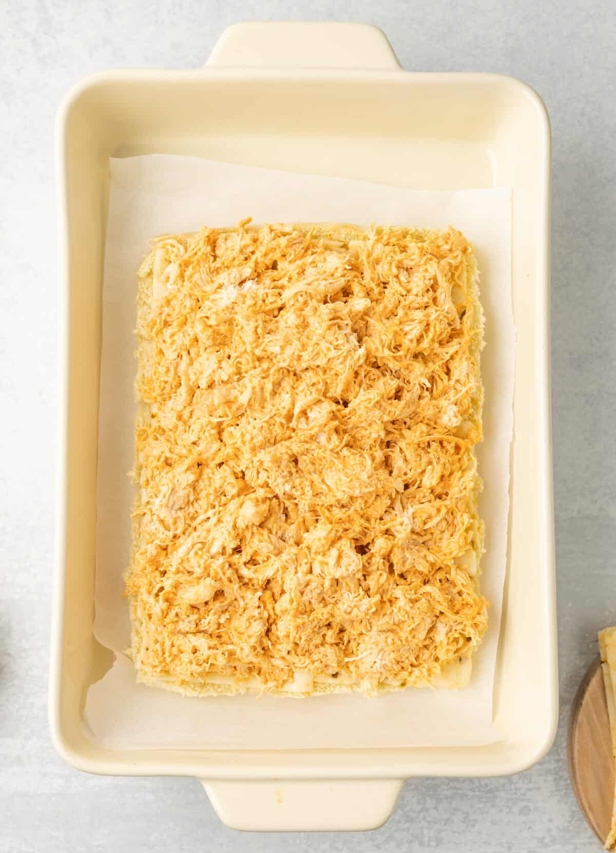 spread the seasoning buffalo chicken over the cheese