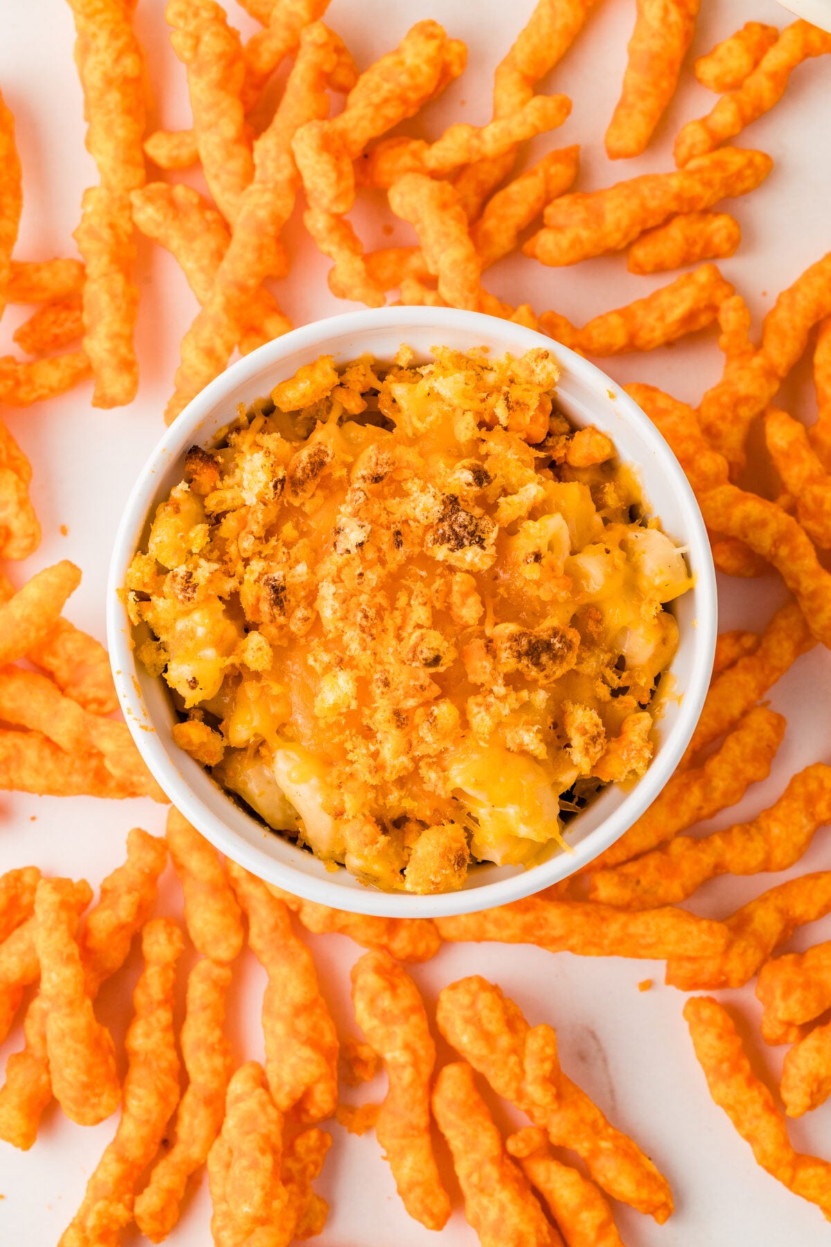 bowl of cheetos mac and cheese surrounded by cheetos