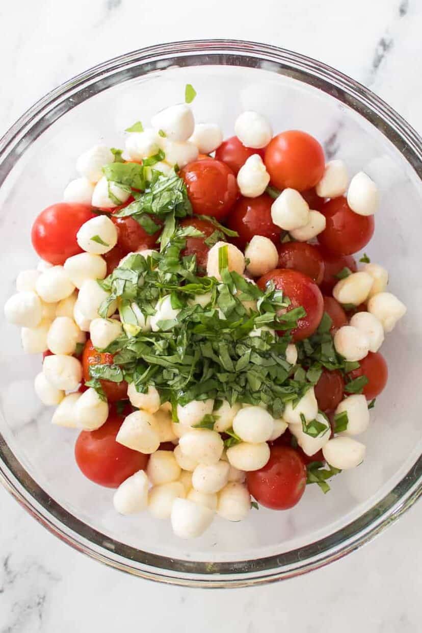 olive oil and salt over the top of caprese salad