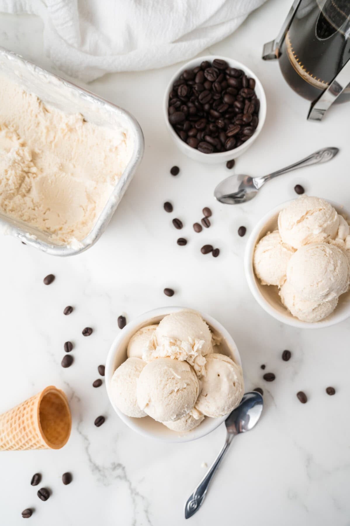 scoops of ice cream in bowls next to loaf pan