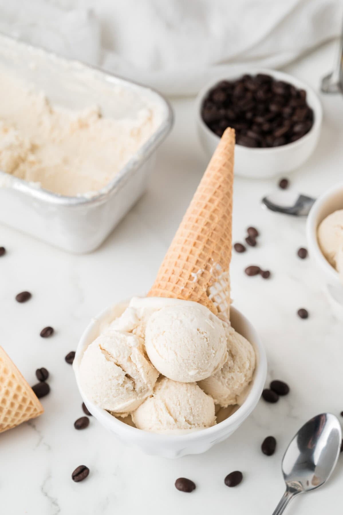 coffee ice cream in a bowl with a waffle cone on top