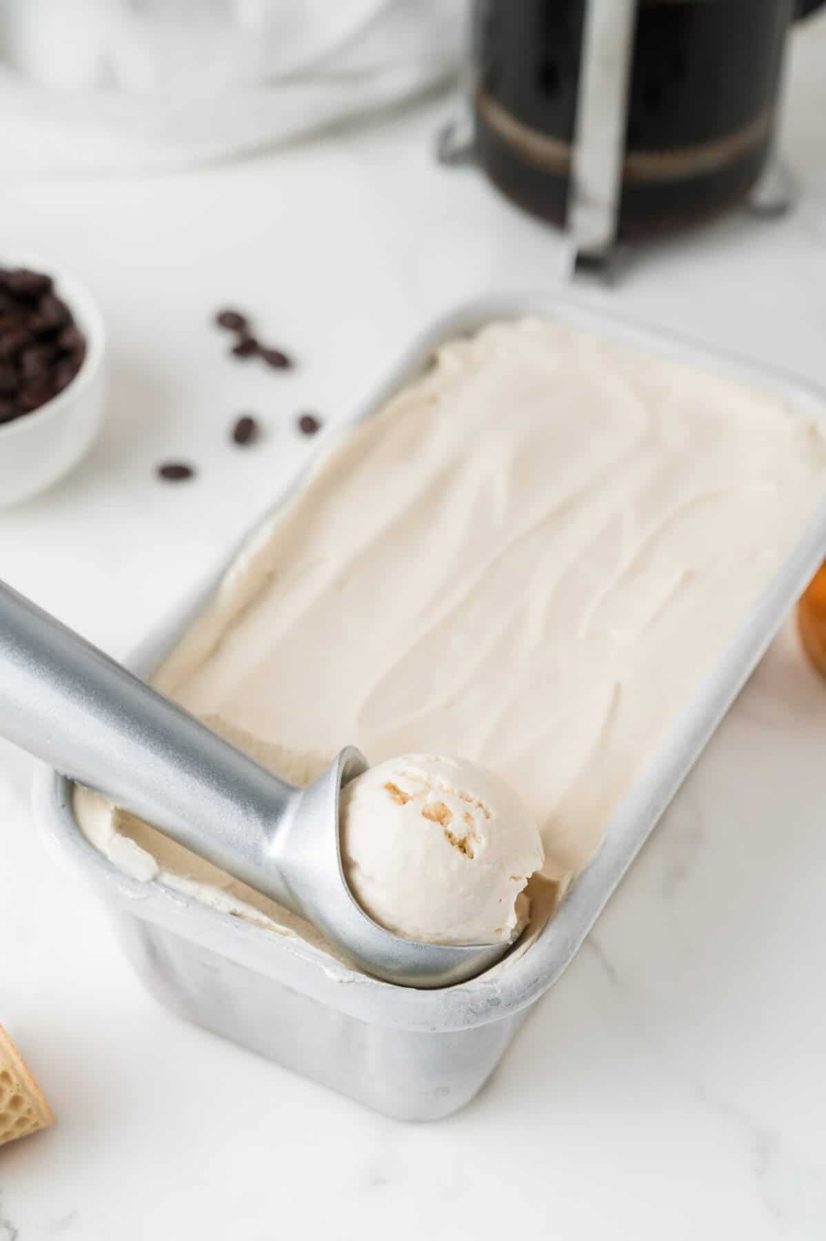 scooping coffee ice cream from loaf pan