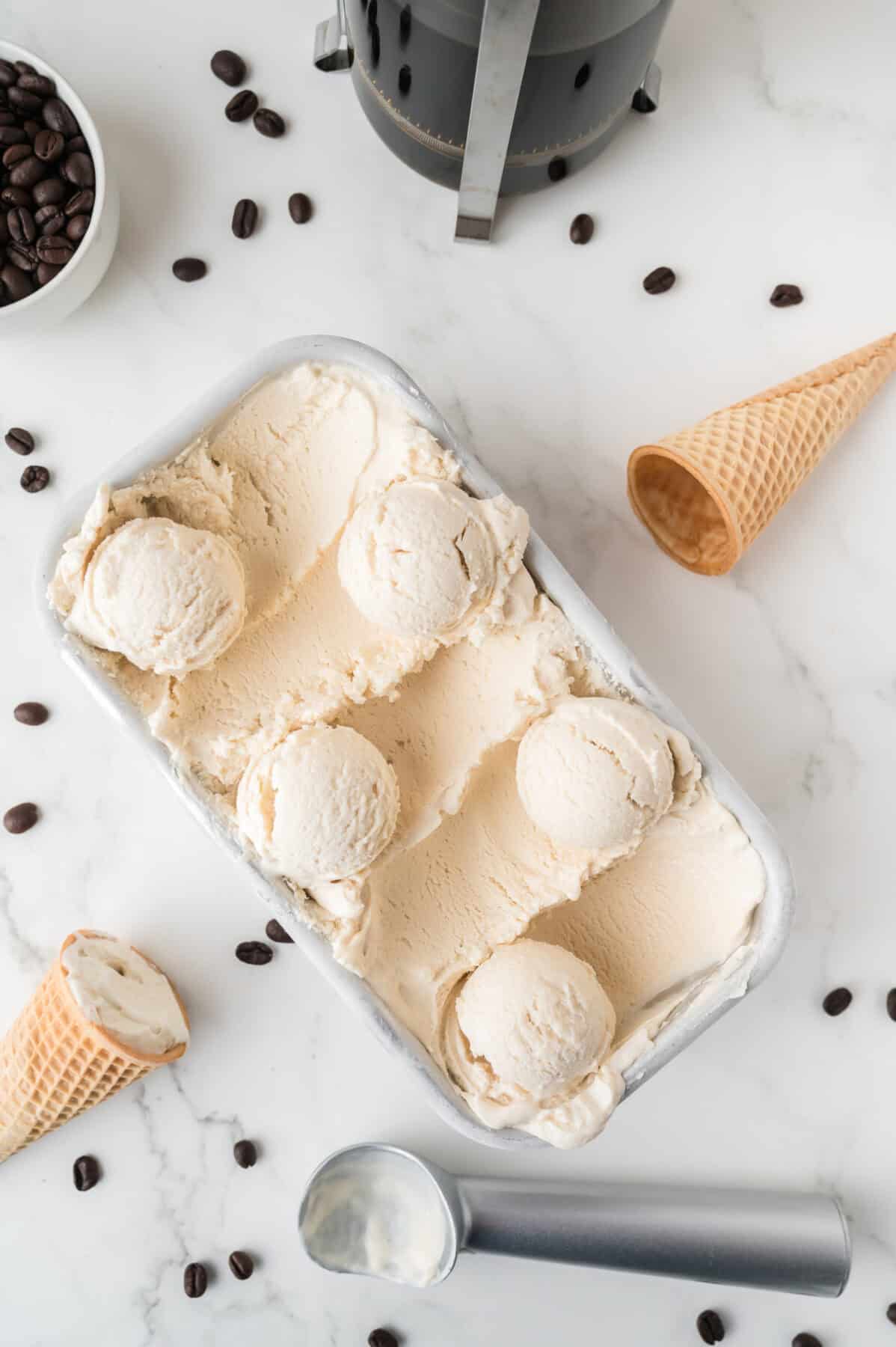 coffee ice cream in a loaf pan with scoops rolled up on each side