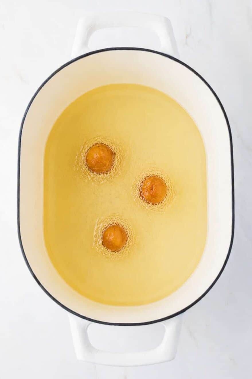 donut holes (cut up biscuits) in oil frying