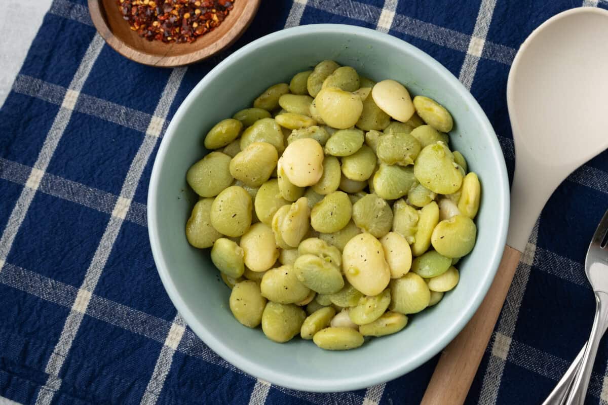 bowl of butter beans next to bowl of red pepper flakes
