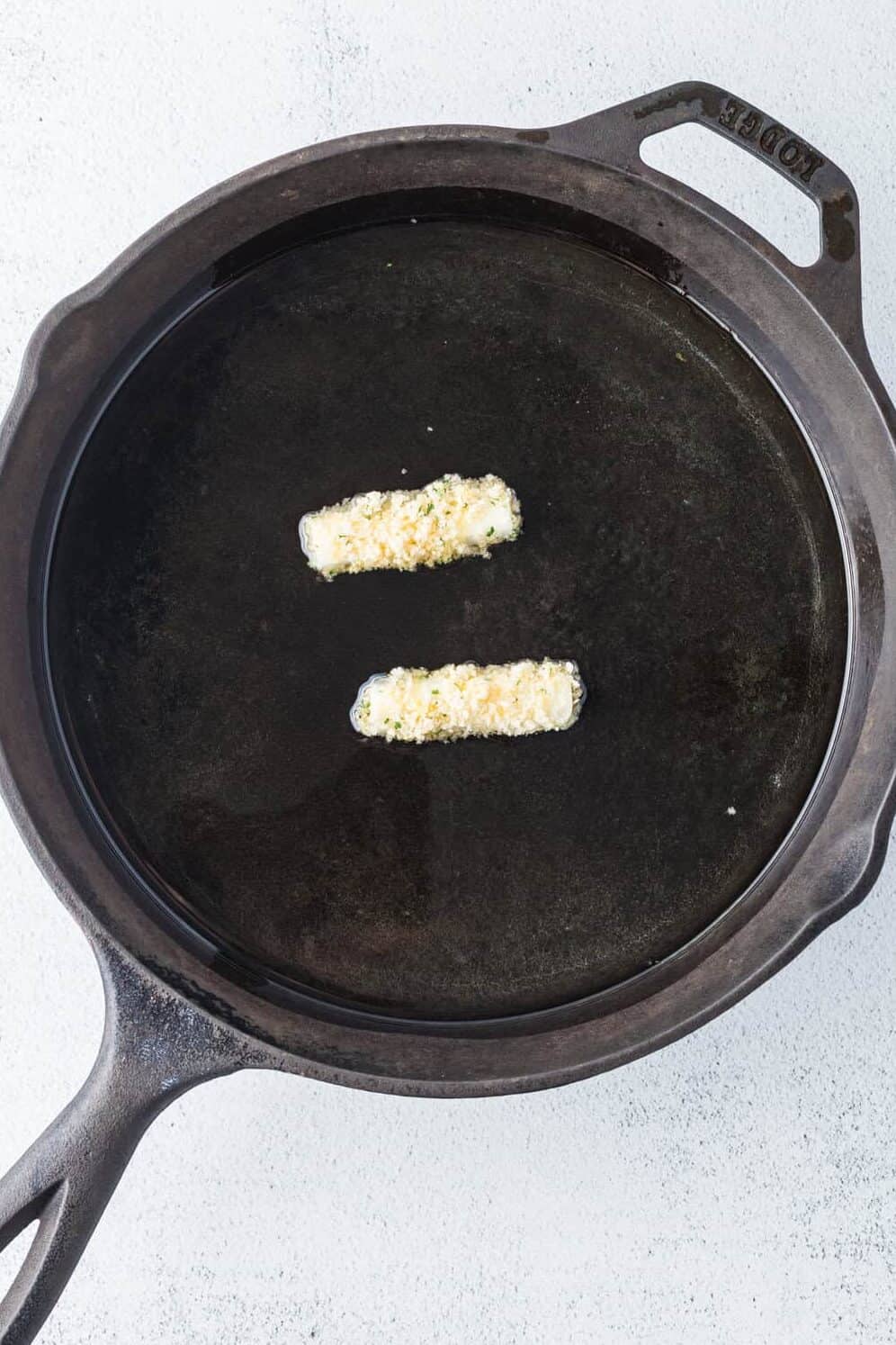 cheesesticks in skillet frying