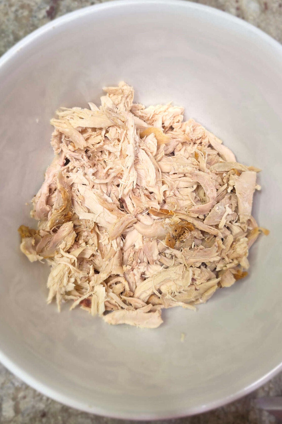 shredded Rotisserie Chicken in a white bowl
 