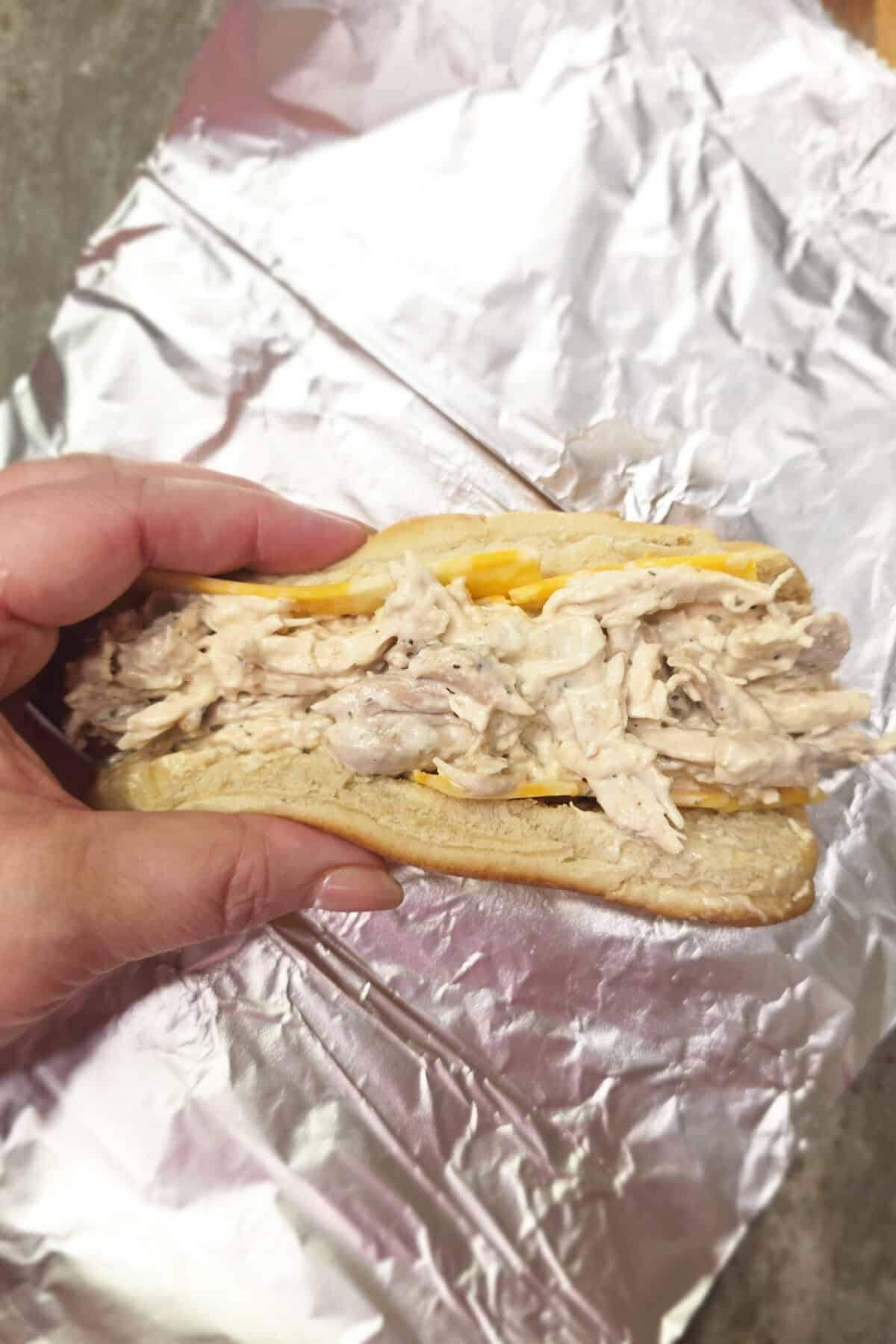 rotisserie chicken sandwich rolled tight on foil