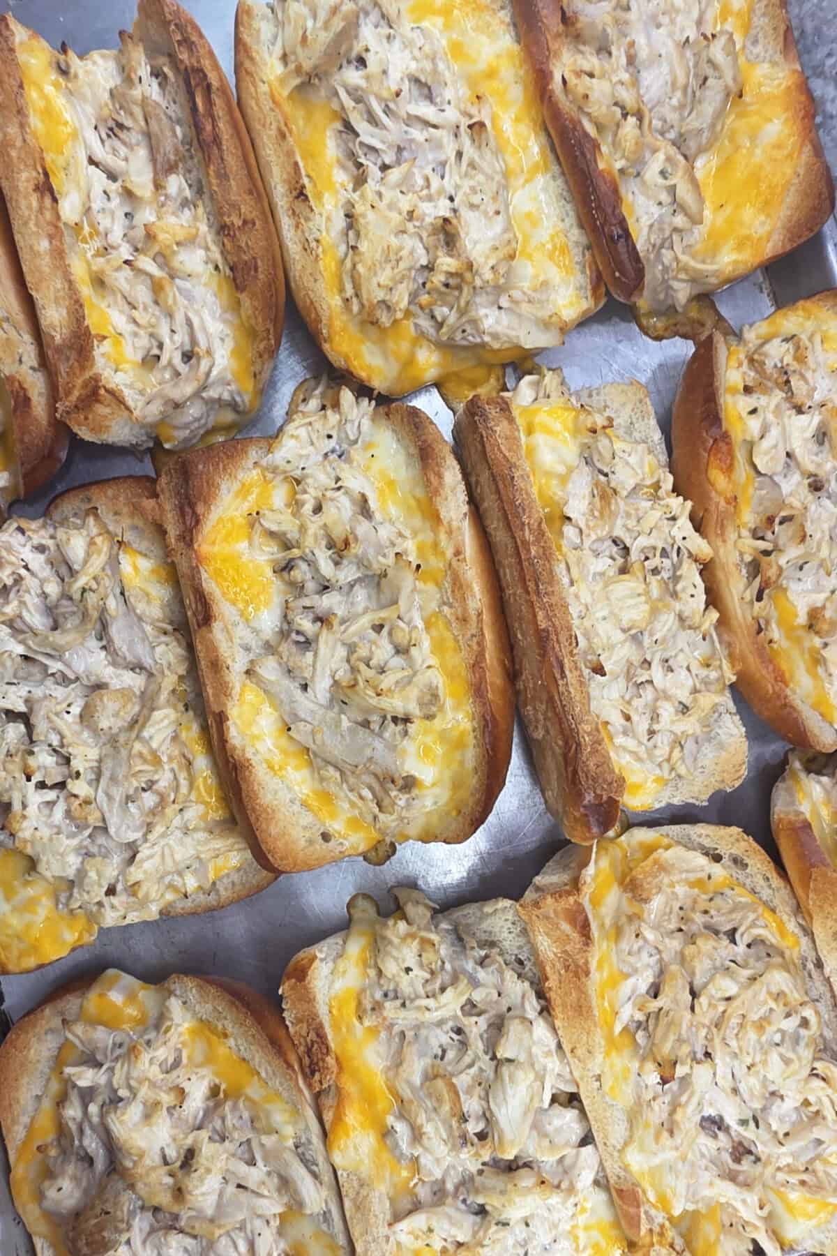 toasted rotisserie chicken sandwiches on a baking sheet