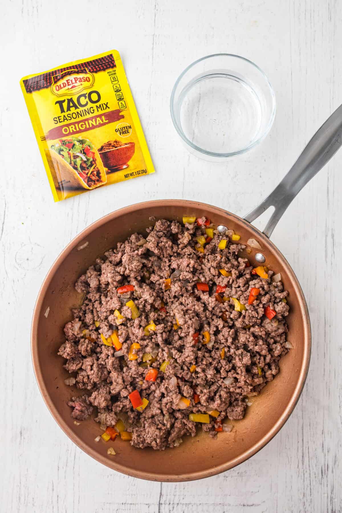 browned meat with veggies in a skillet