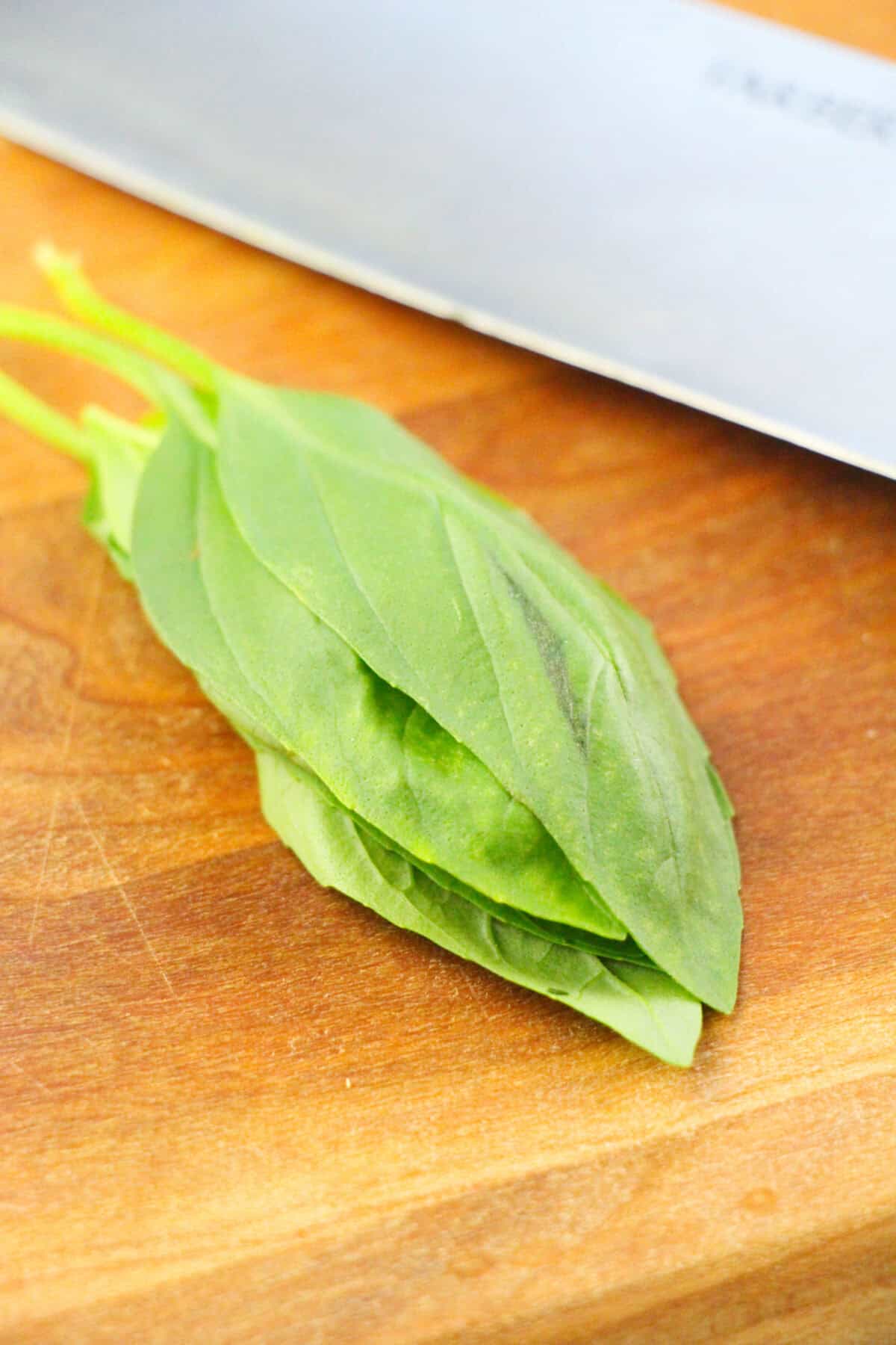 basil leaves on a cutting board